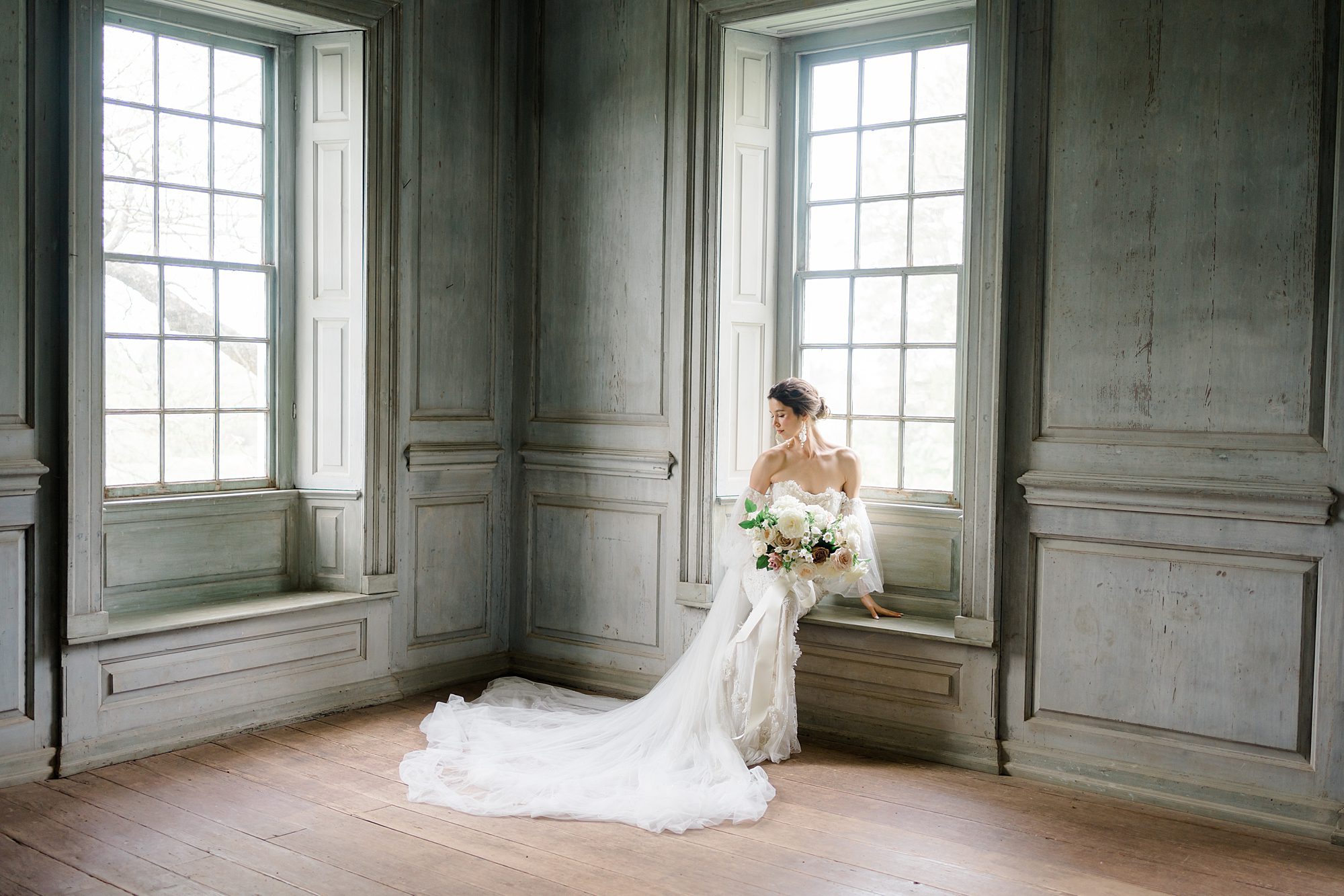 bride sits on bench by window