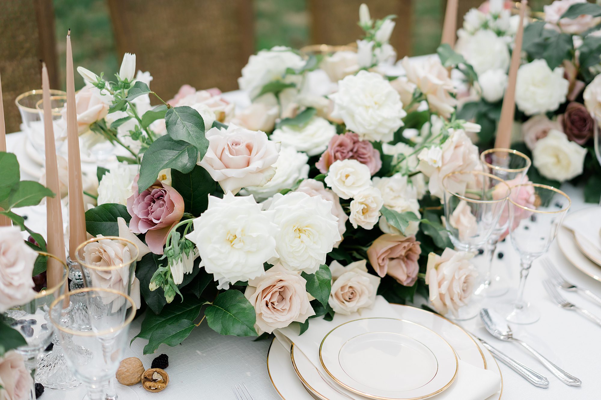 white plates with gold embellishments and flower centerpieces from Historic Salubria Wedding