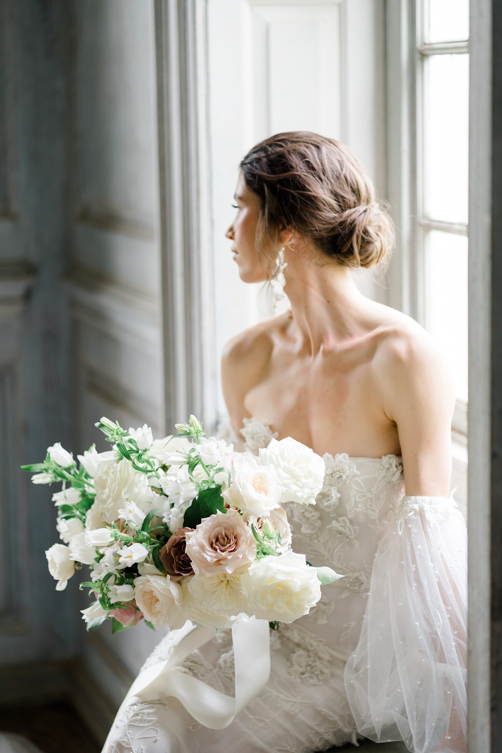bride turns to the side showing her low bun hair style