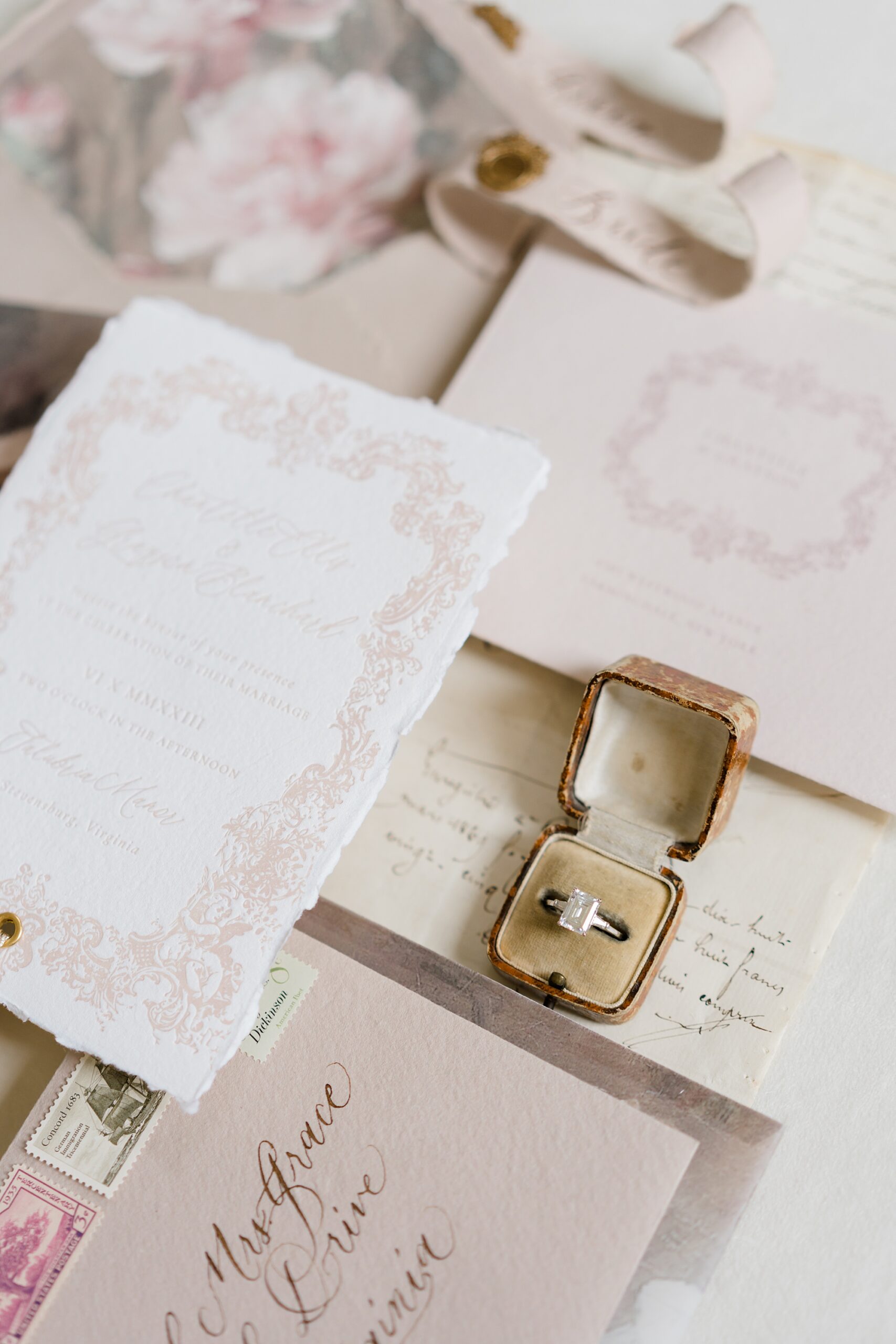 ring in gold ring box on invitations