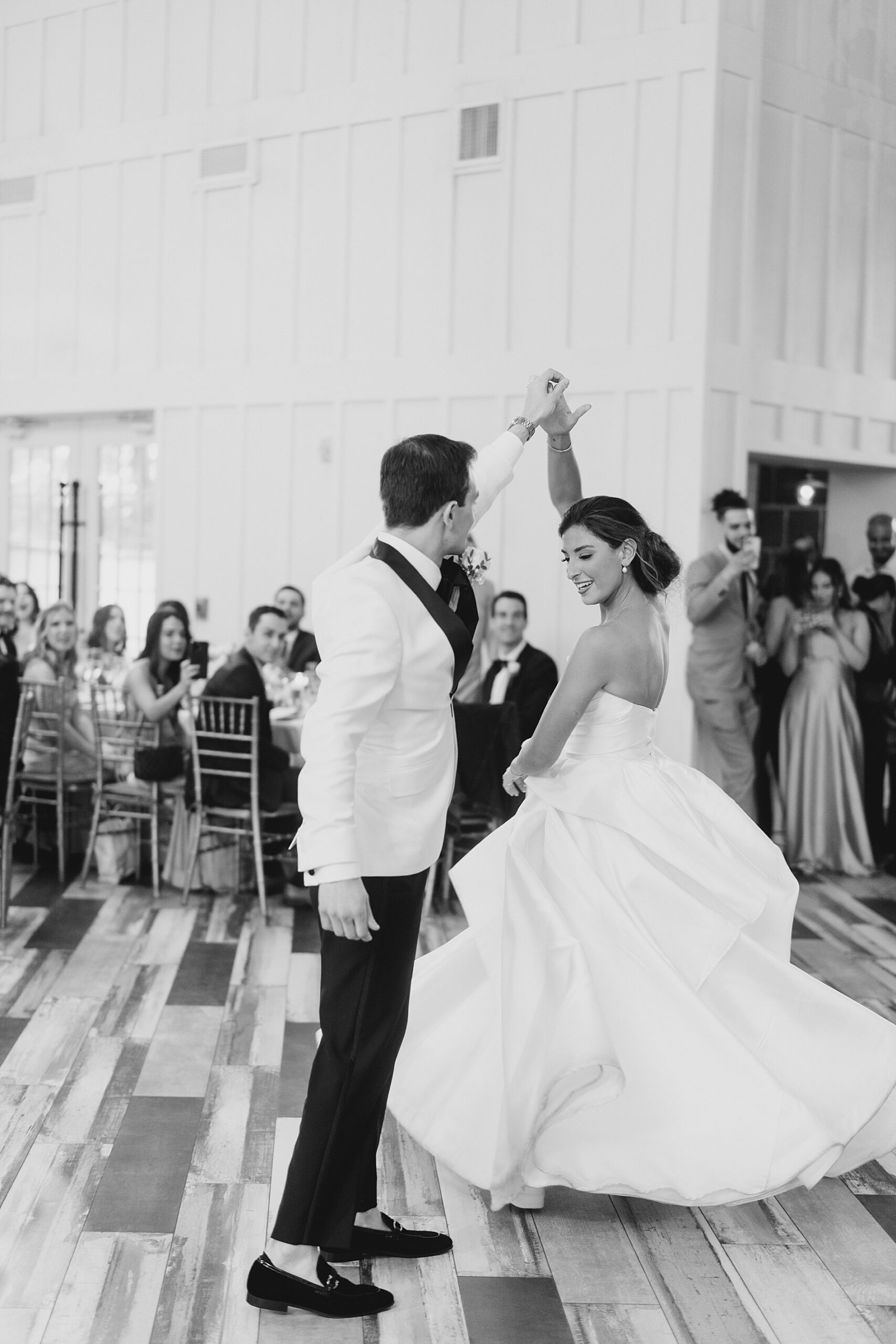 groom twirls bride on the dance floor
