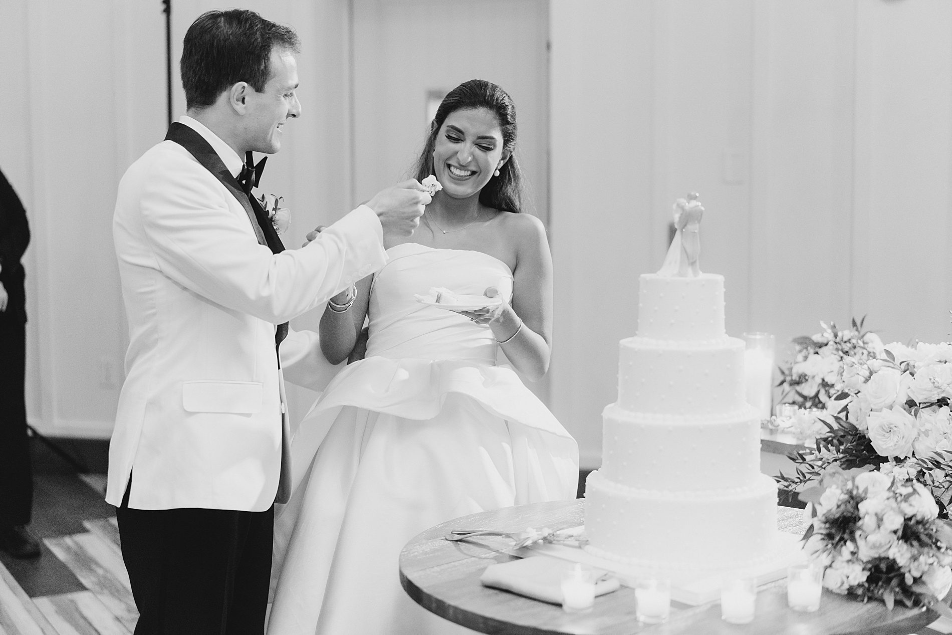 bride and groom feed each other cake