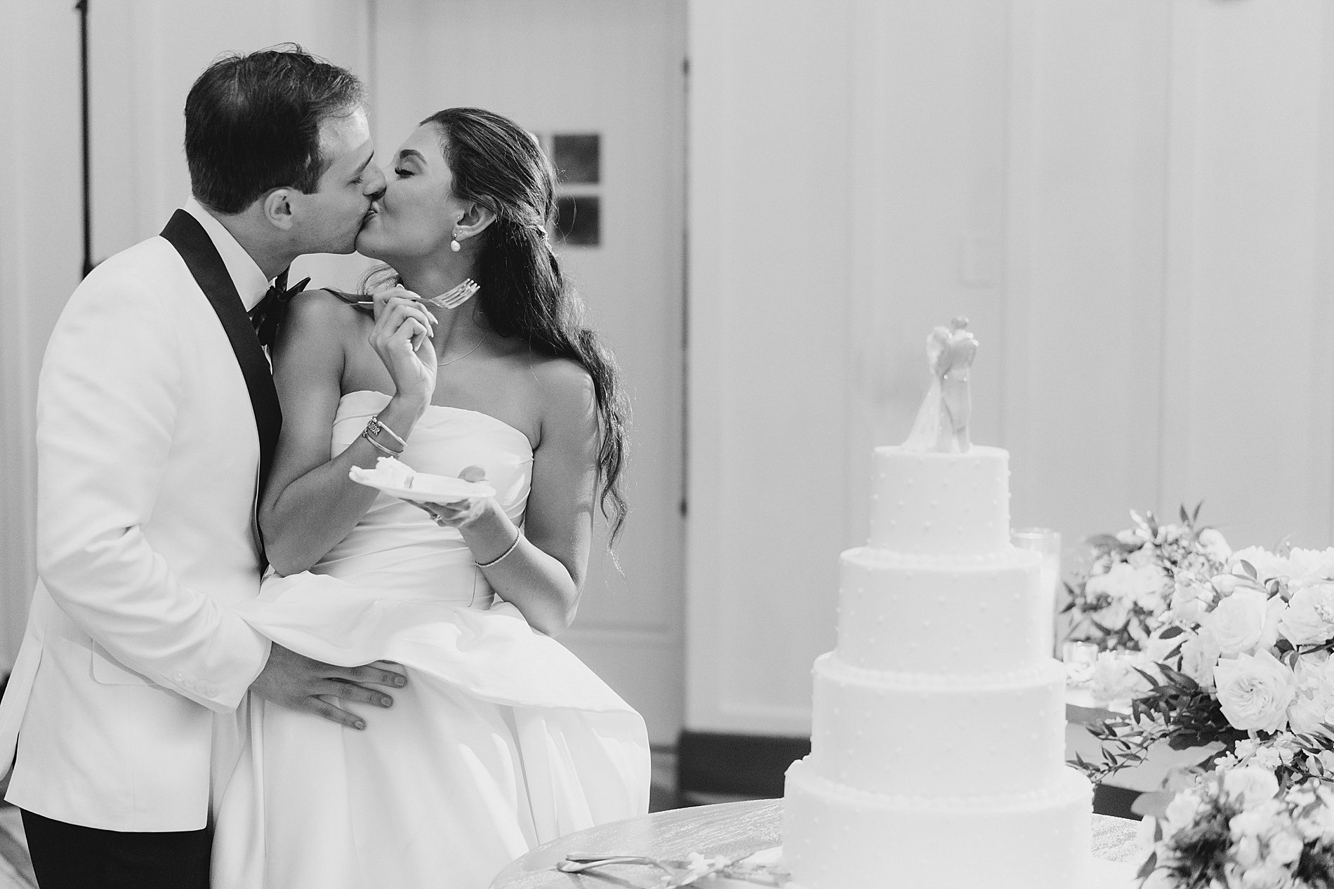 newlyweds kiss with cake