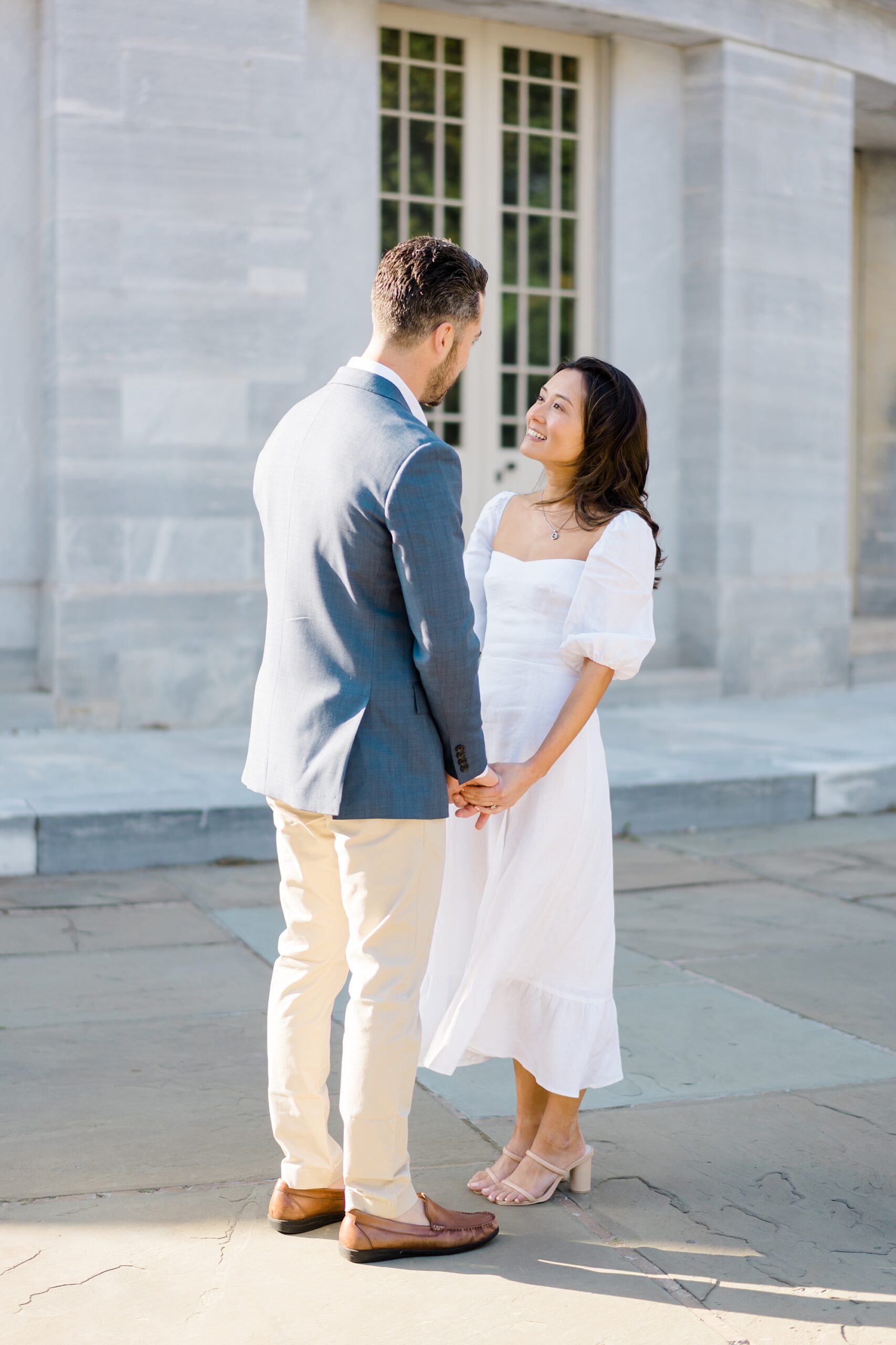 couple stand in front of Merchants Exchange Building during Romantic Old City Philadelphia Engagement Session