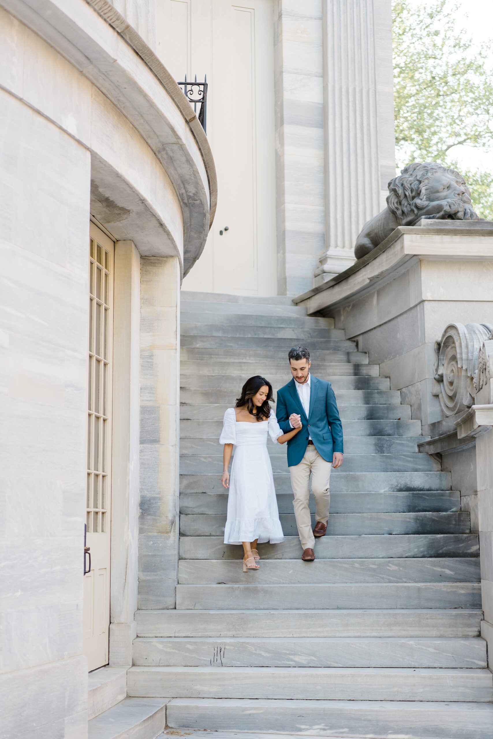 engaged couple hold hands walking down staircase during Romantic Old City Philadelphia Engagement Session