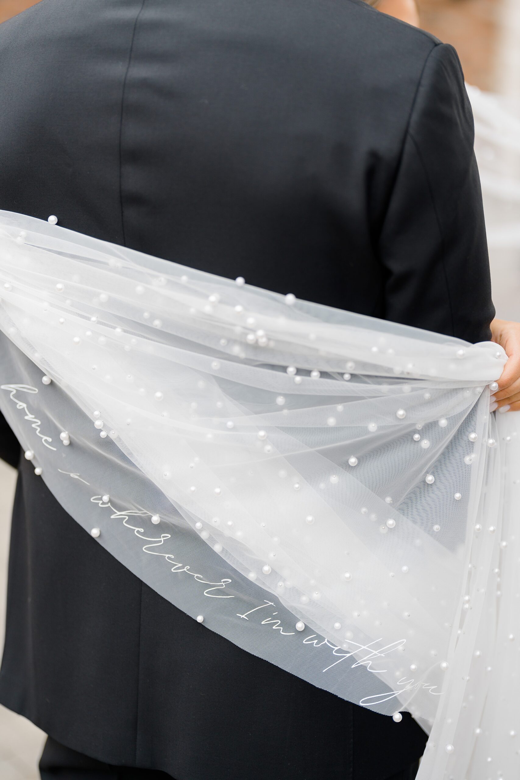 bride's veil decorated with pearls and quote