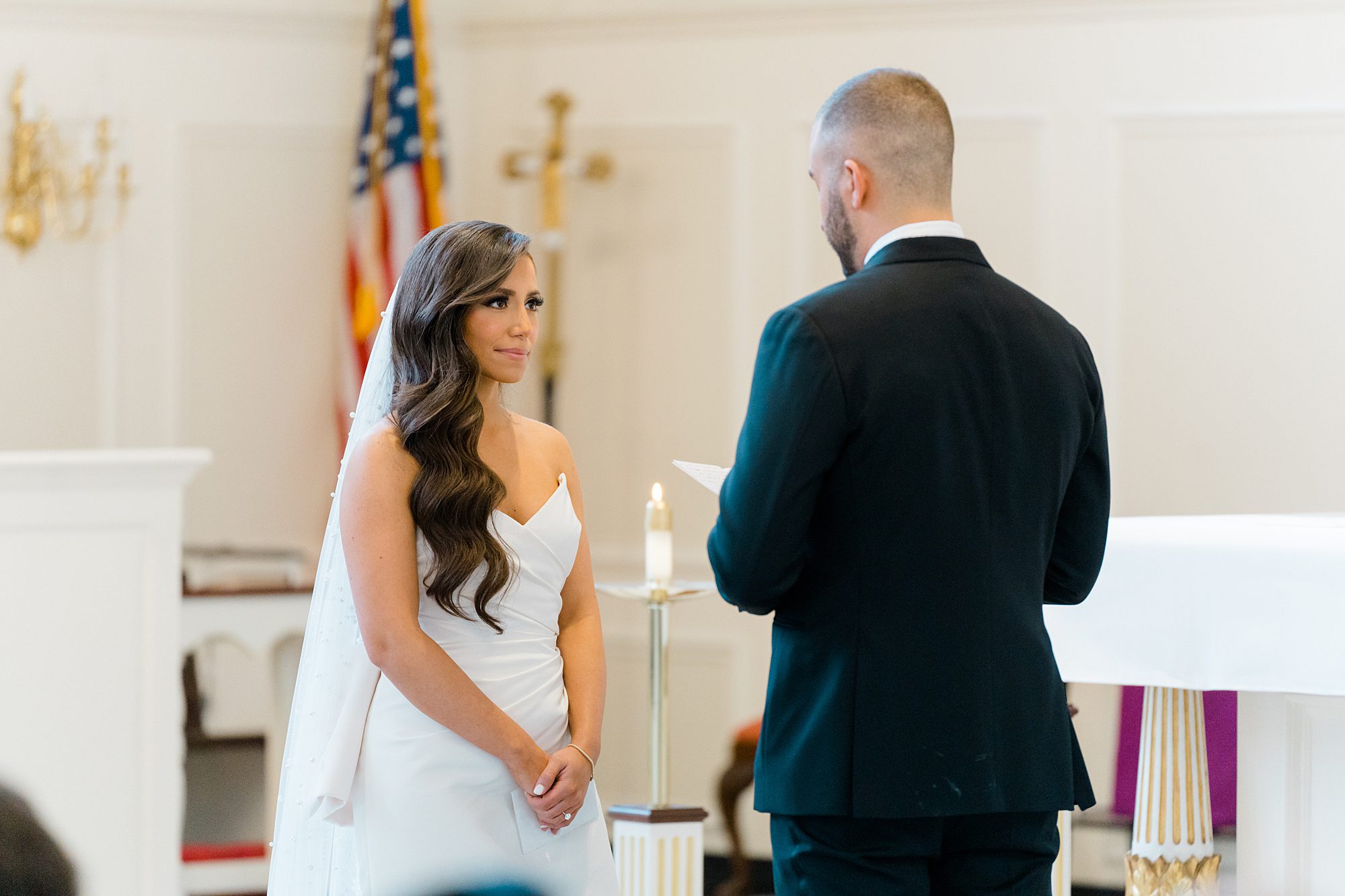 groom reads vows to bride during church ceremony