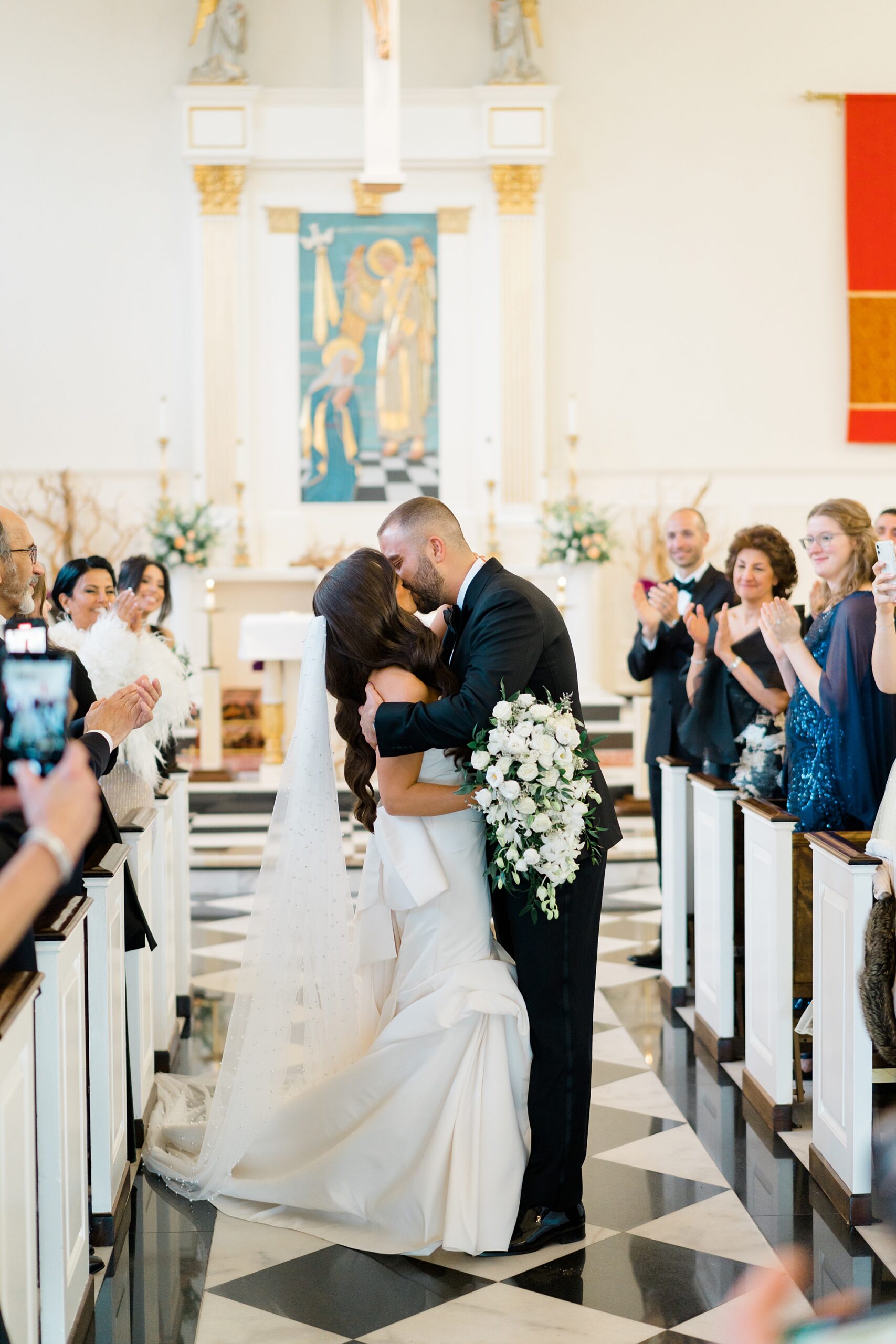 couple kiss as they exit church 
