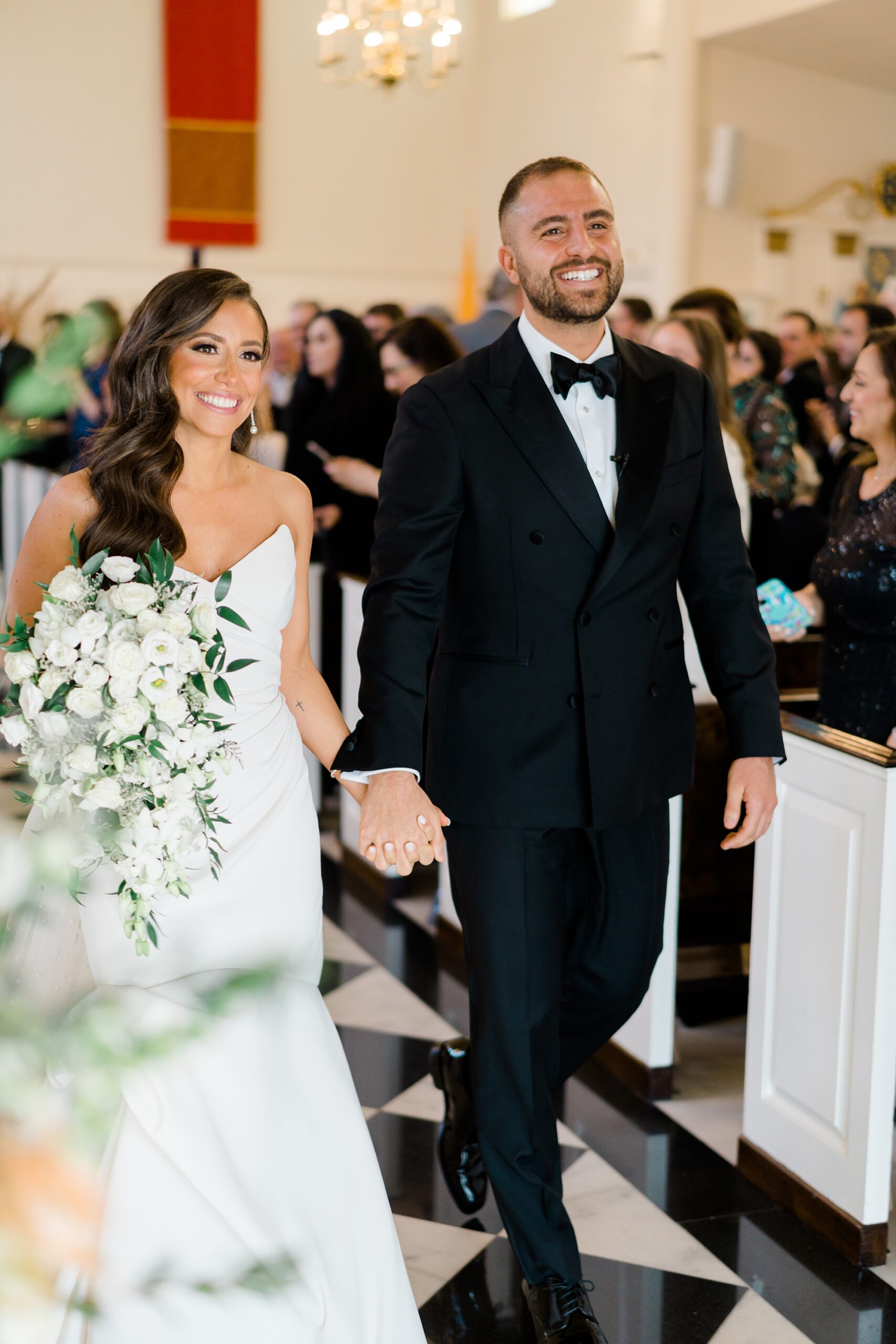 newlyweds are beaming as they exit the church ceremony 