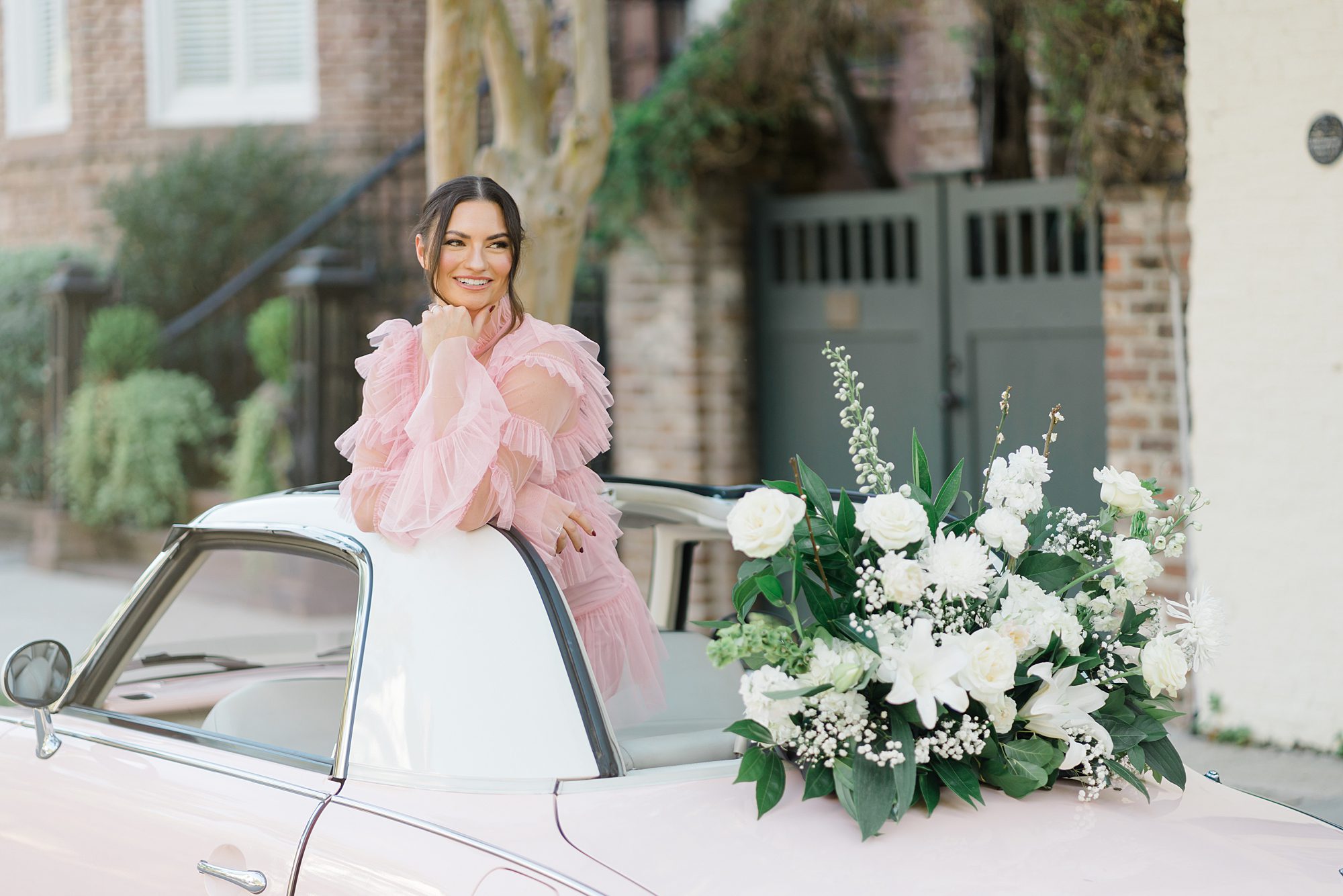 white floral arrangements decorate the pink Figgy during this fun Charleston photoshoot