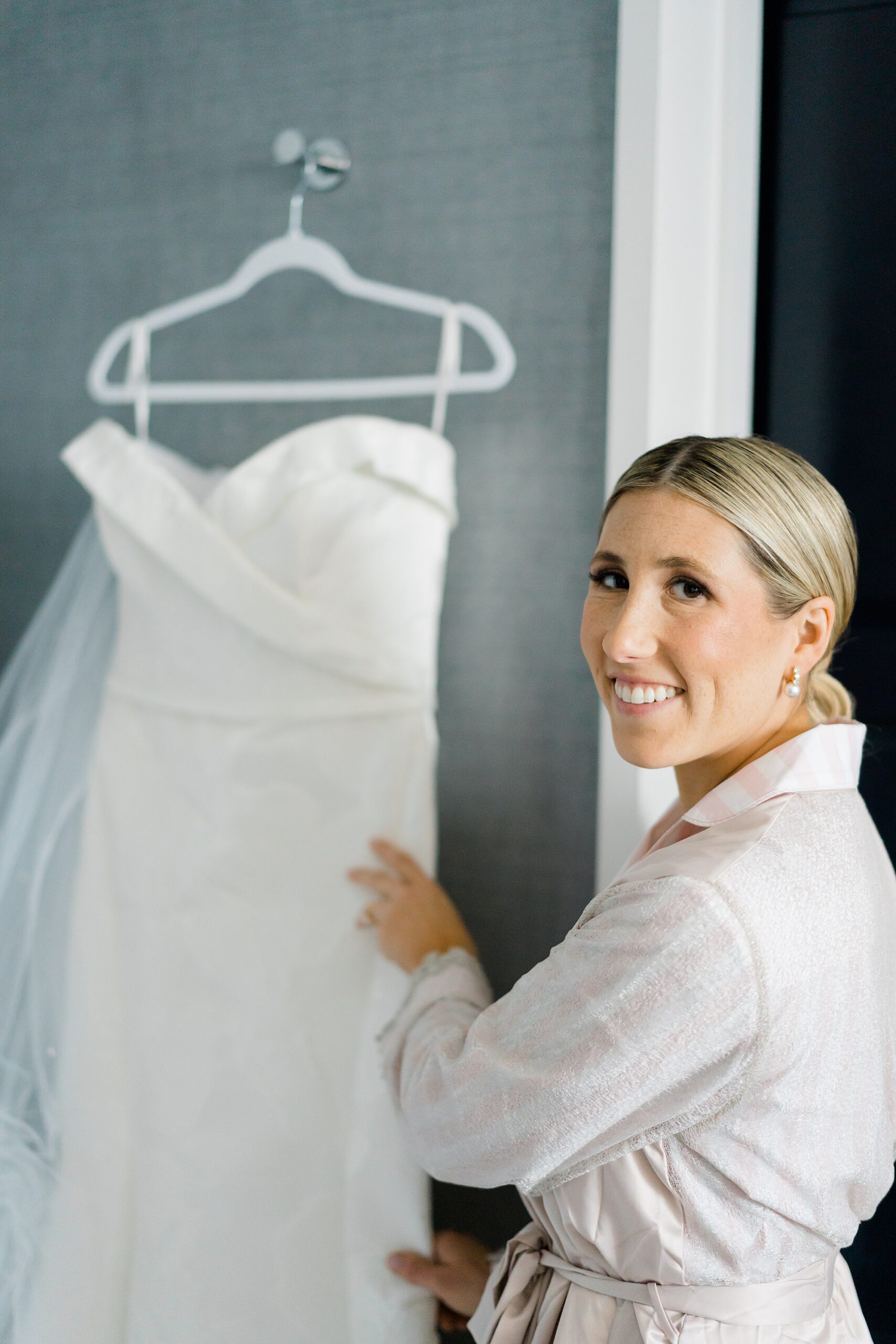 bride admires wedding dress