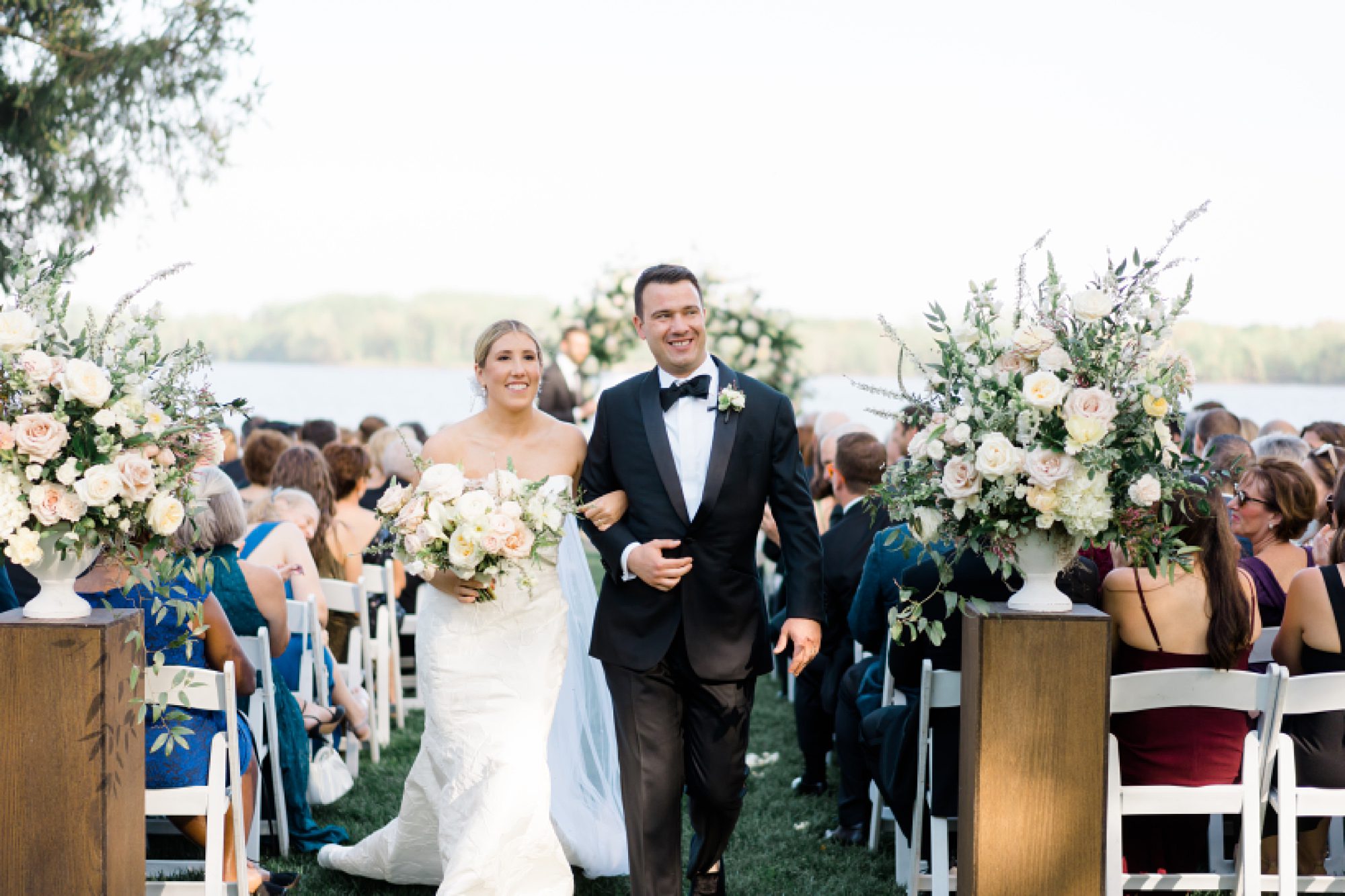 bride and groom exit waterfront wedding ceremony at Glen Foerd on the Delaware in Philadelphia