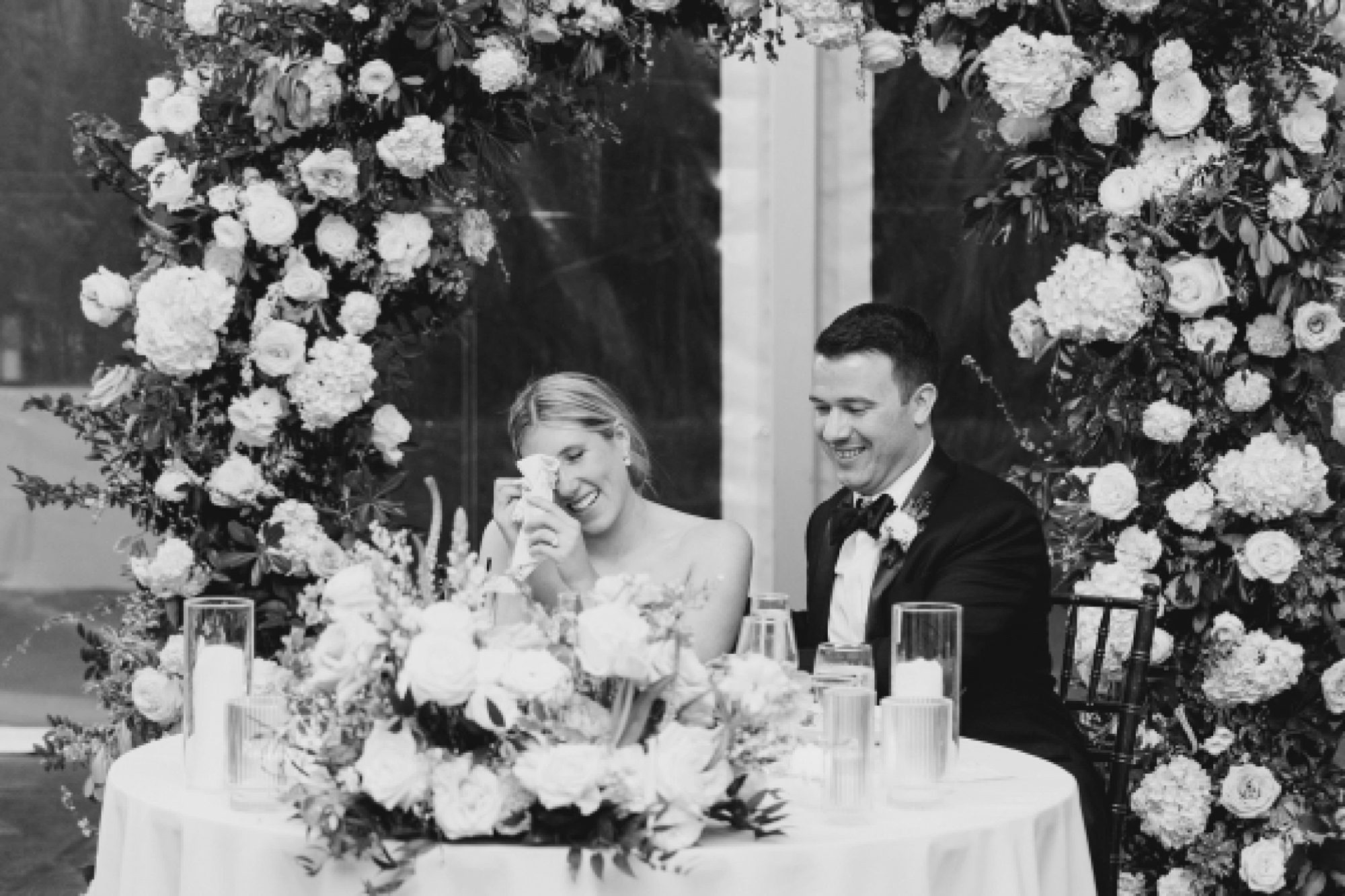 candid moment as couple listen to wedding speeches