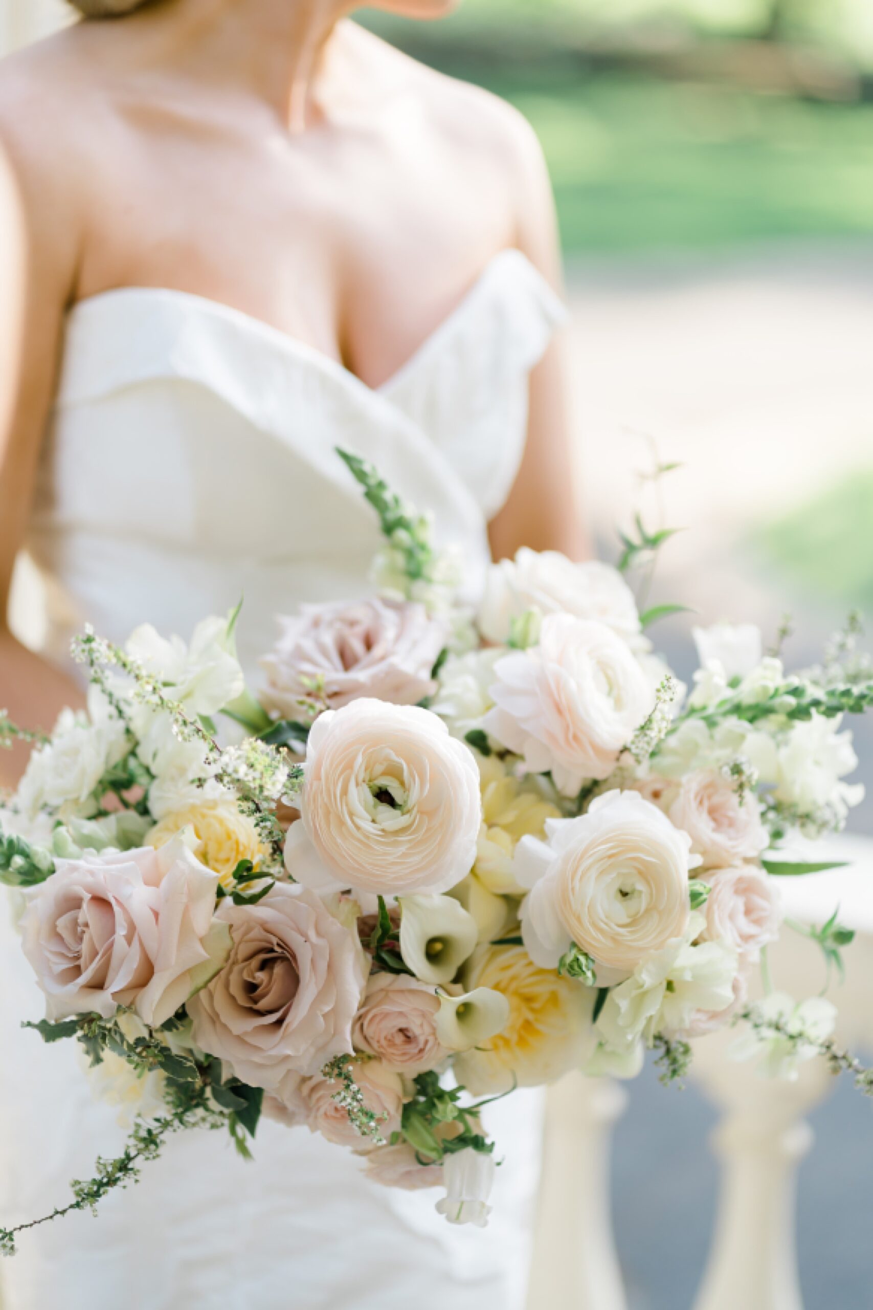 bride holding elegant arrangement of flowers