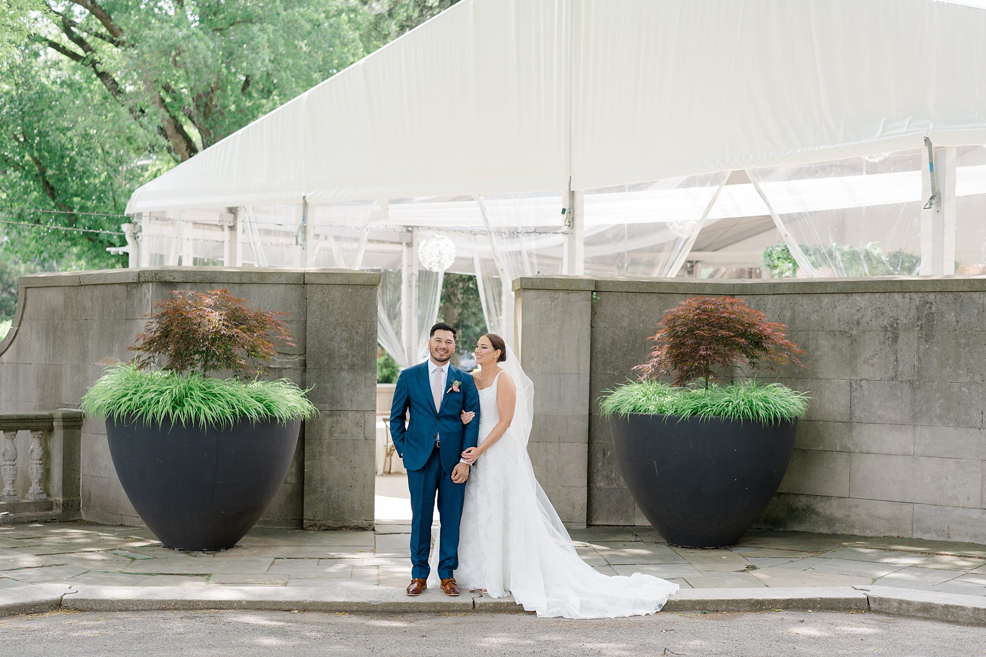 couple in front of outdoor tent at Romantic Curtis Arboretum Wedding