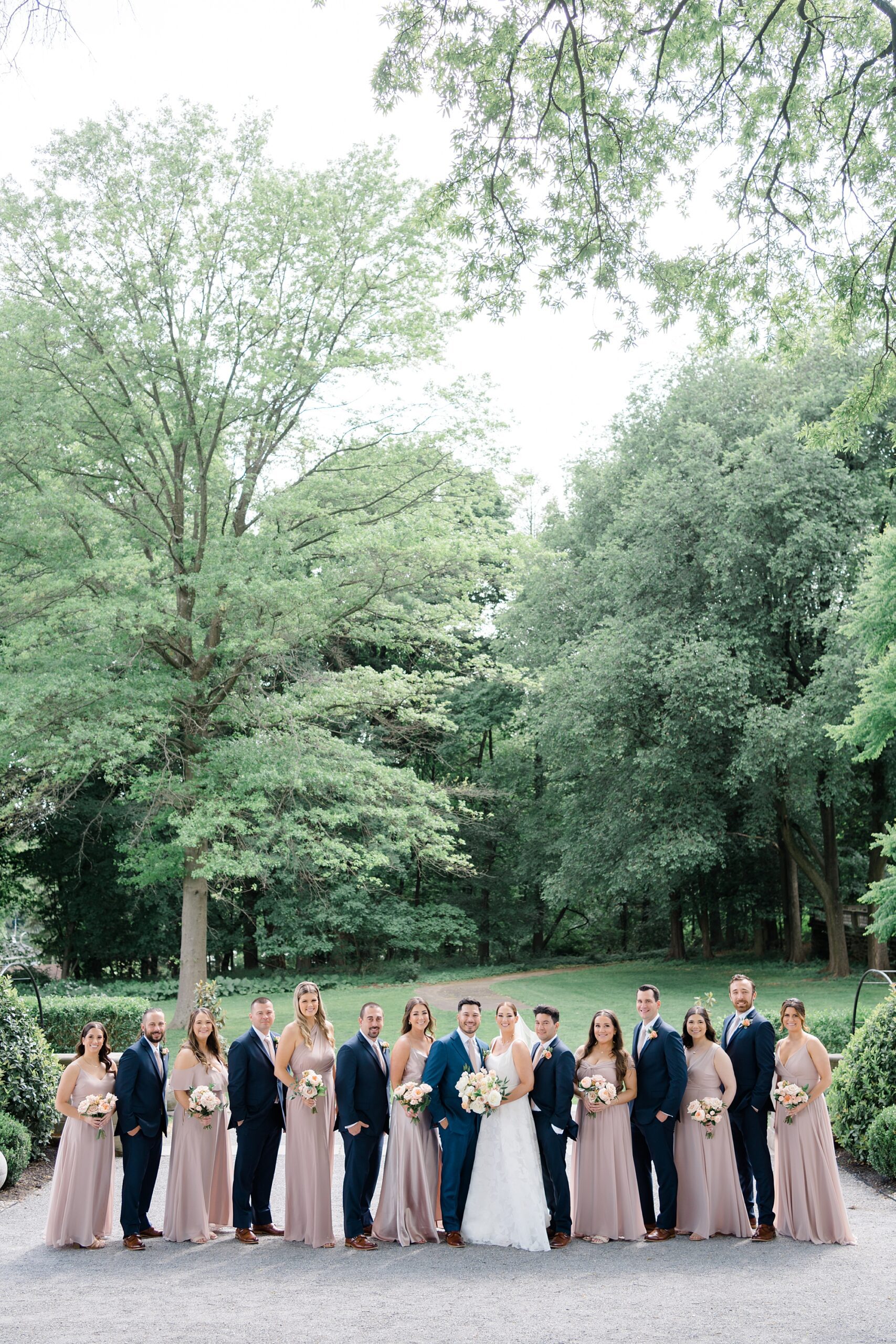 bridesmaids in dusty pink dresses and groomsmen 