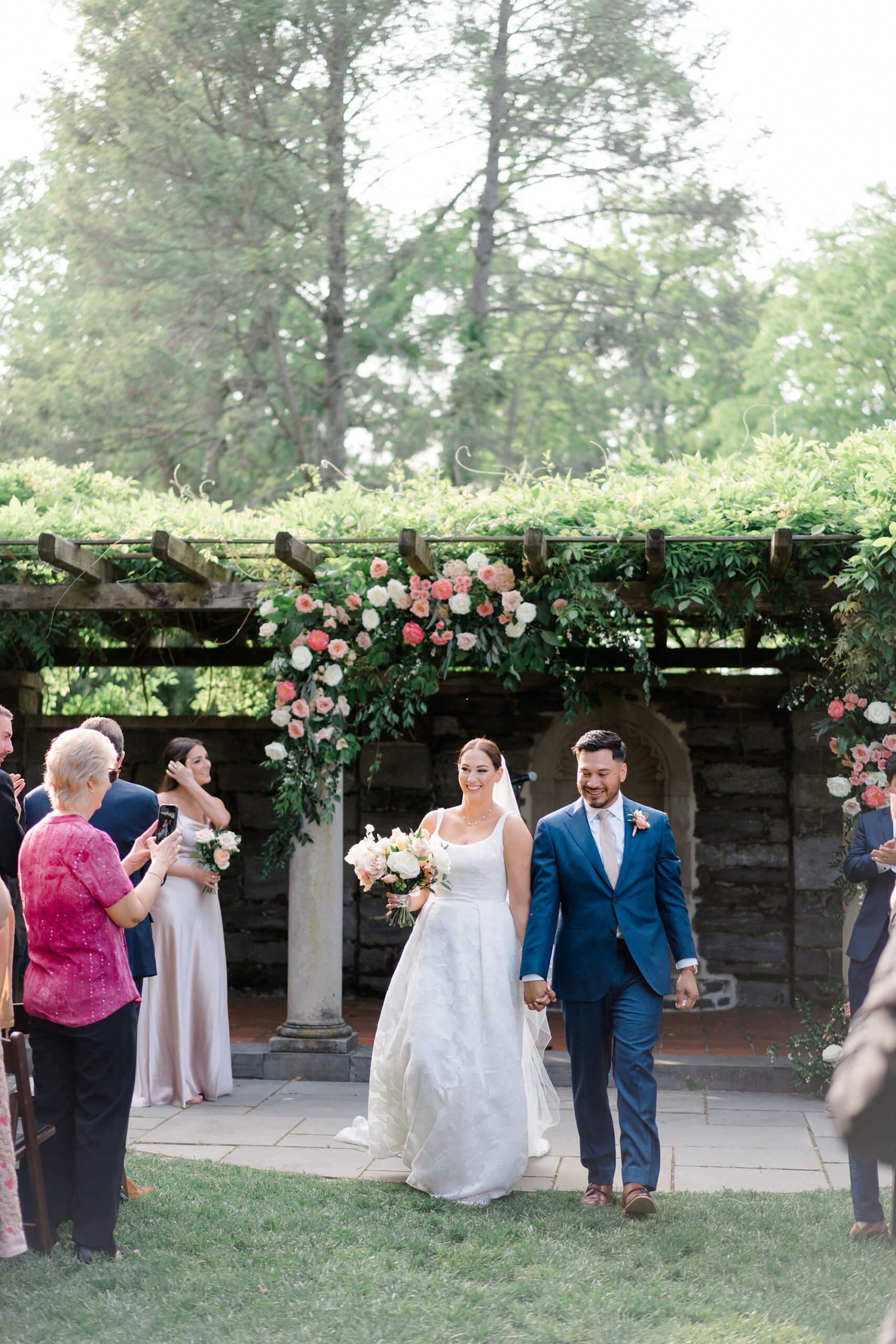 newlyweds exit outdoor wedding ceremony at Curtis Arboretum