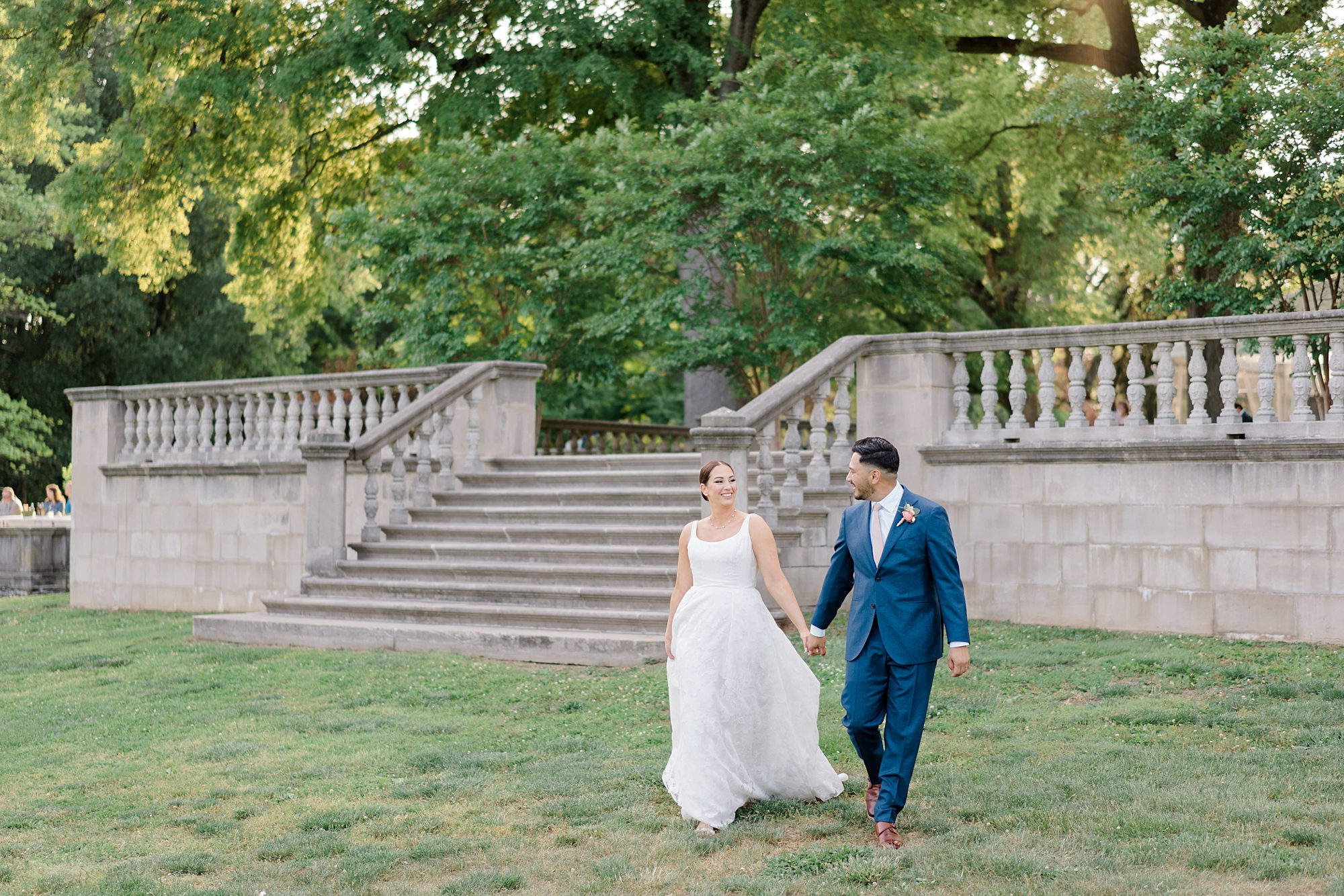 newly weds walk across the grounds of Curtis Arboretum in Philadelphia 