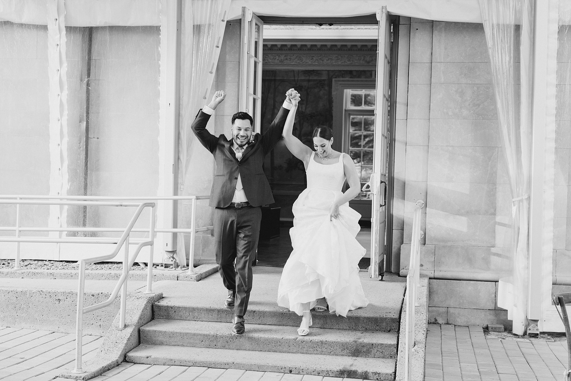 newlyweds celebrate as they enter wedding reception