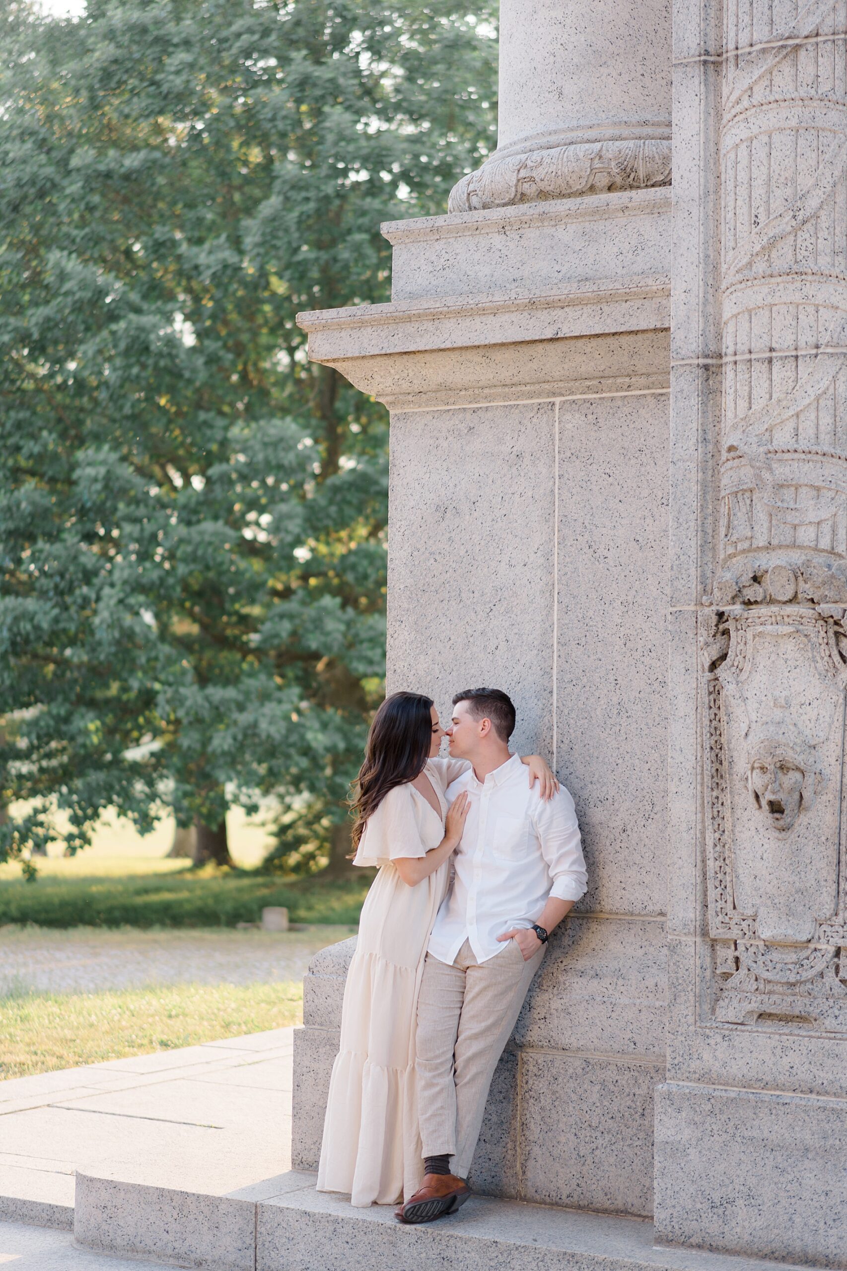 couple lean against historical building at Valley Forge, Pa