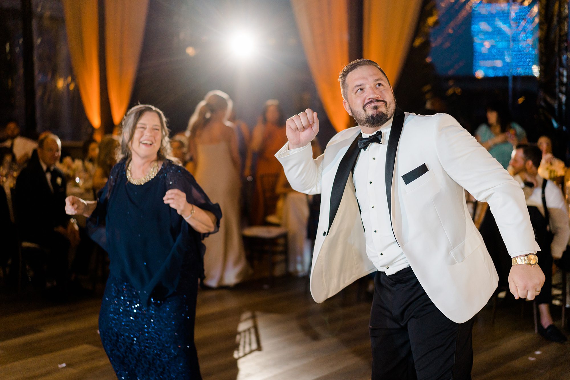 mother + son enjoy a fun dance at wedding reception