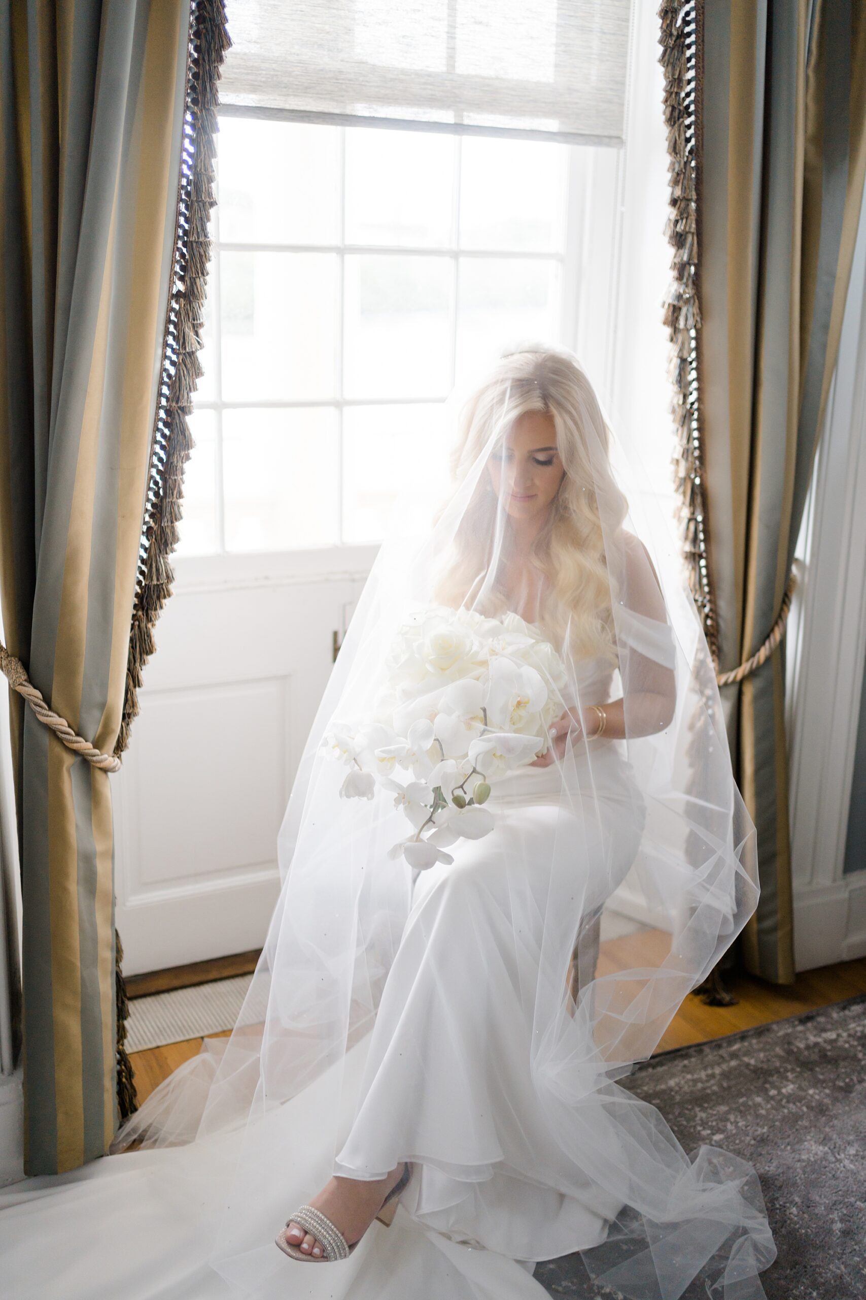 bride sitting by window 