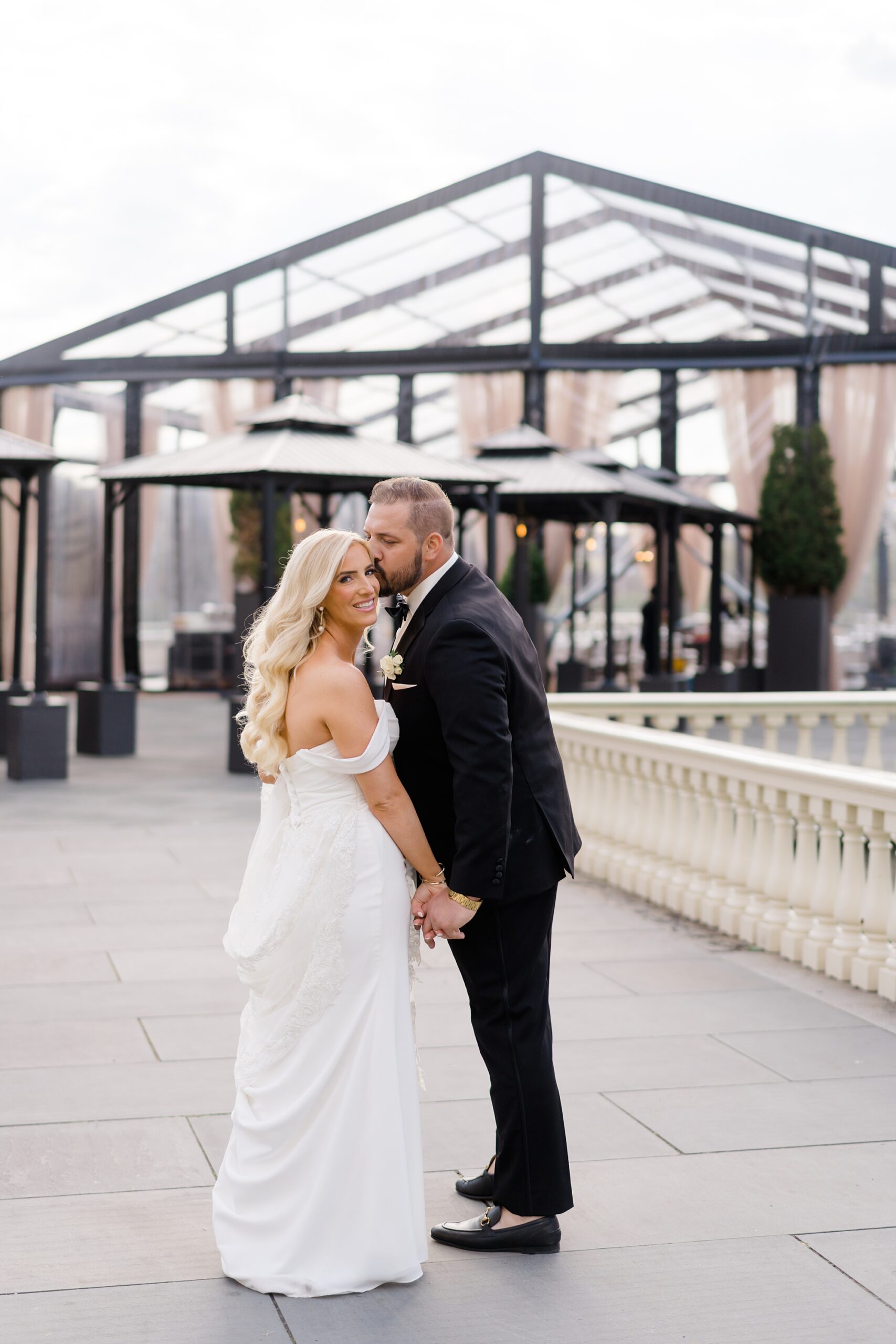 newlyweds kiss outside of Water Works reception 