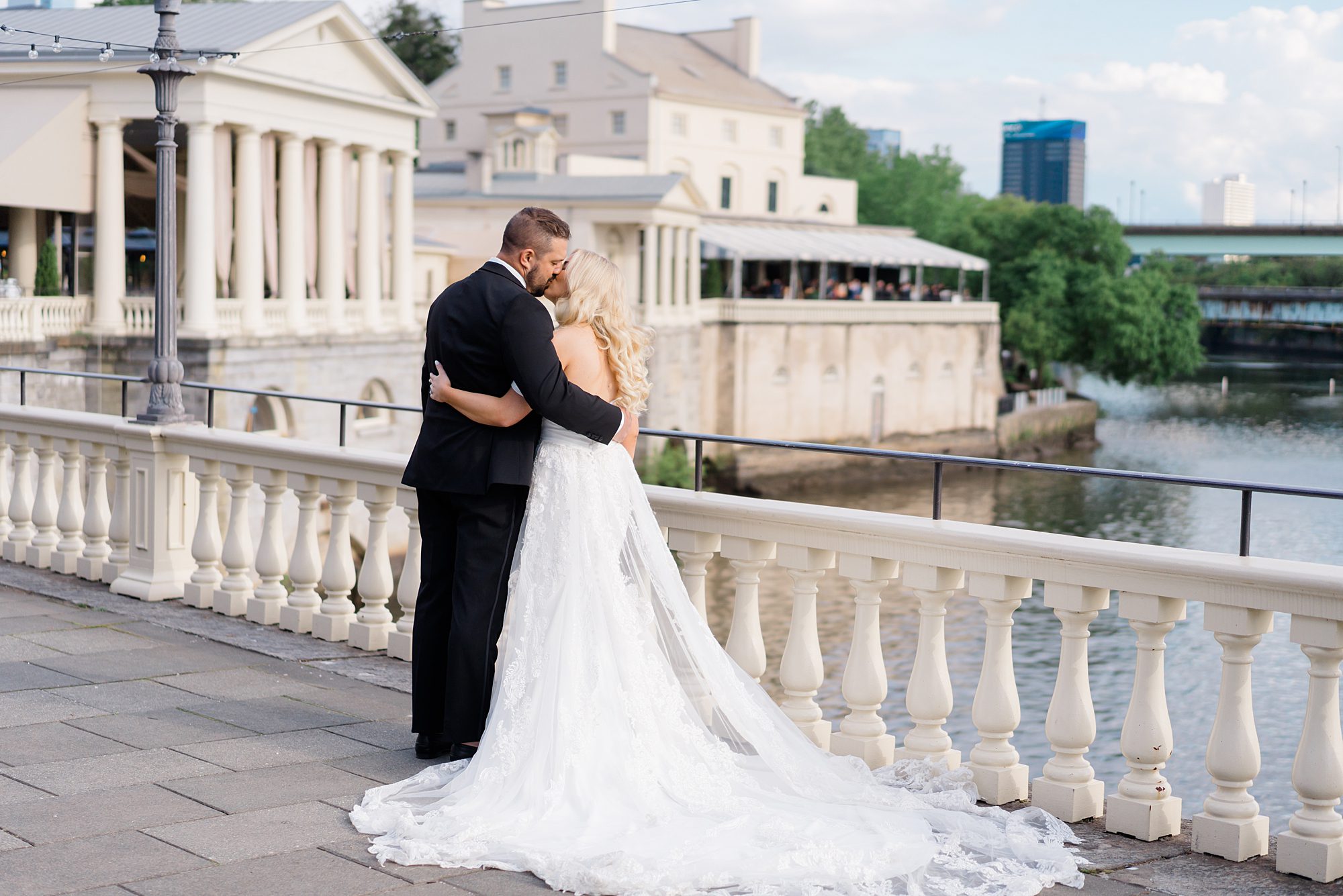 newlyweds kiss outside of Water Works wedding venue 