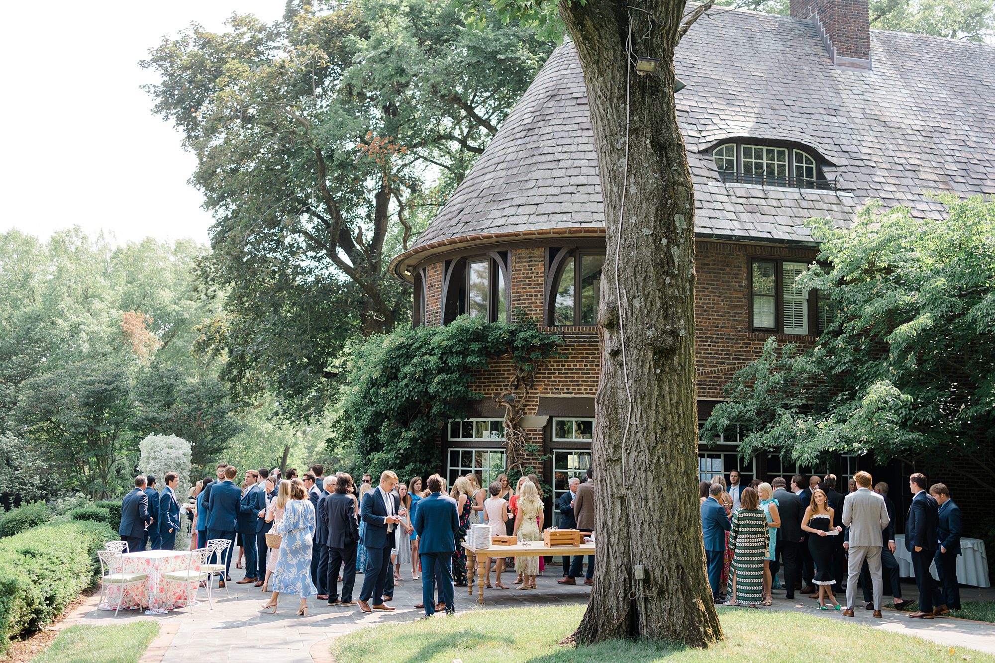 wedding guests gather outside of Greenville Country Club during cocktail hour