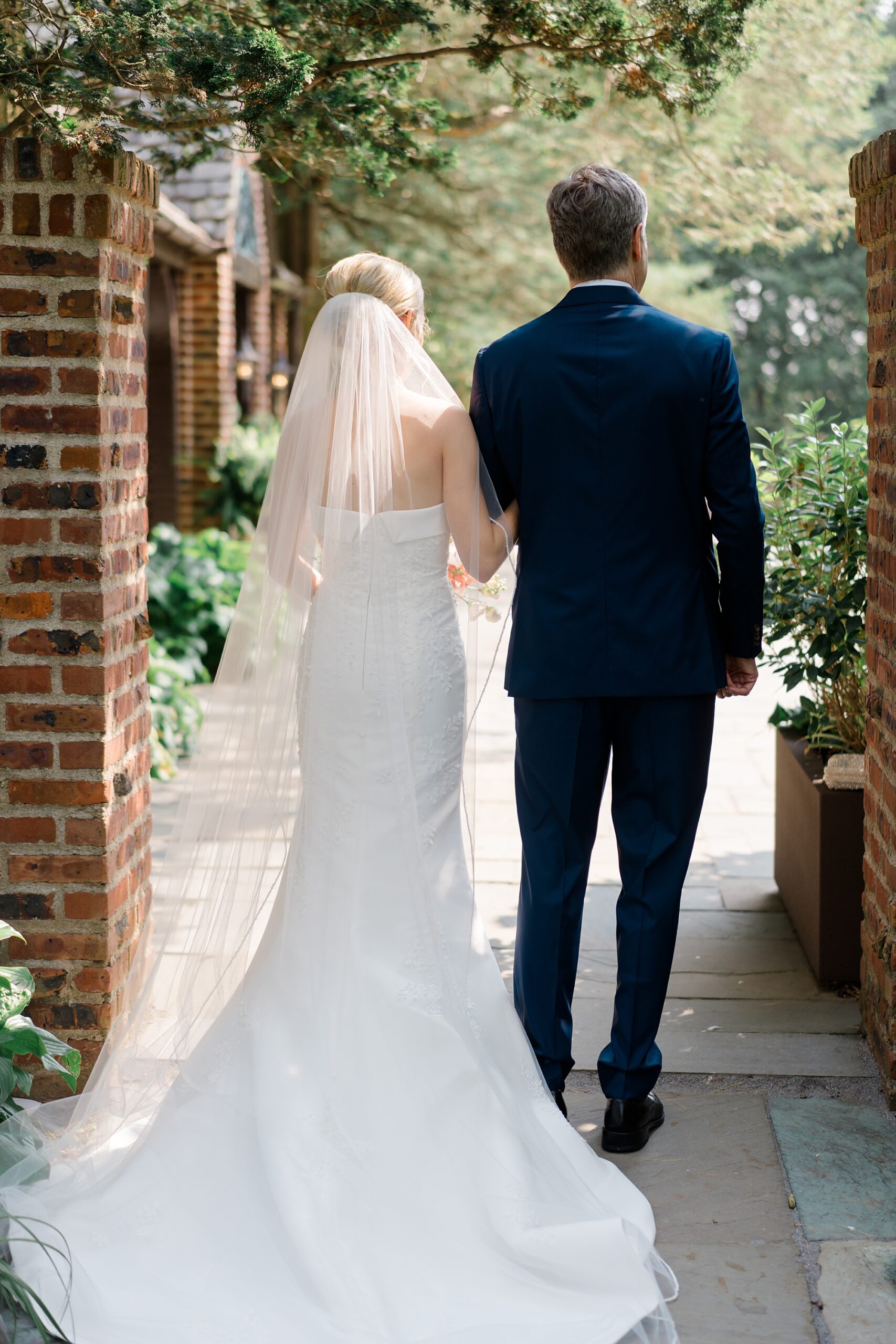 bride walks with father down the aisle 