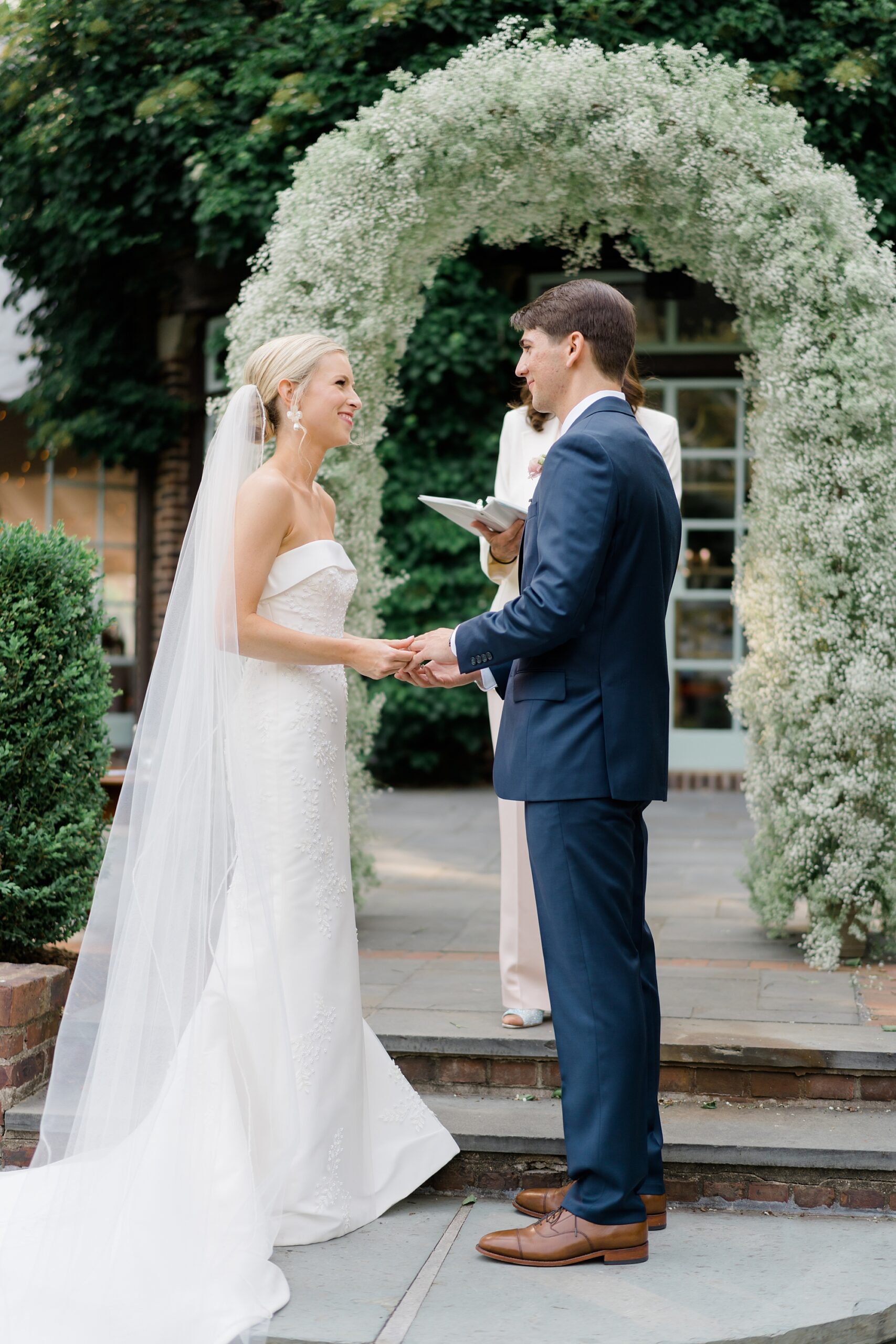 bride and groom exchange vows during outdoor summer wedding