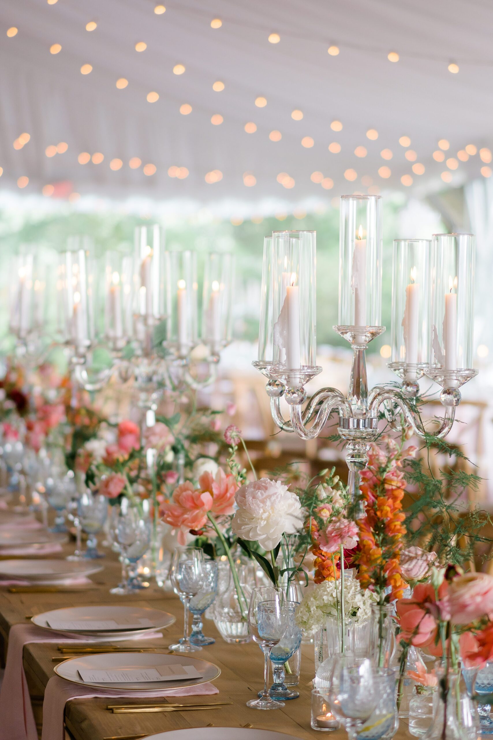 floral centerpieces and white candles in clear candle holders 