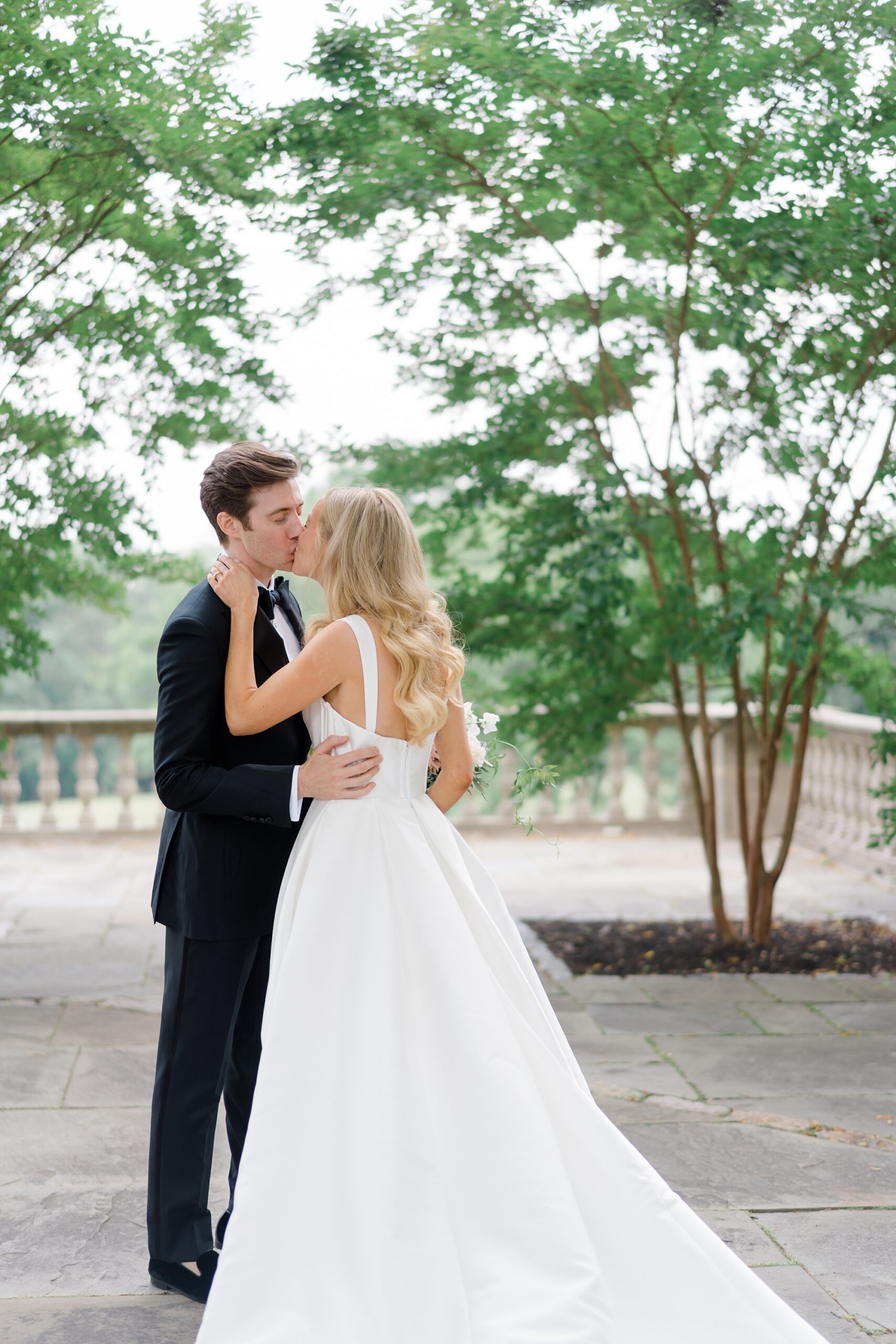 couple kissing during first look moment at Curtis Arboretum 