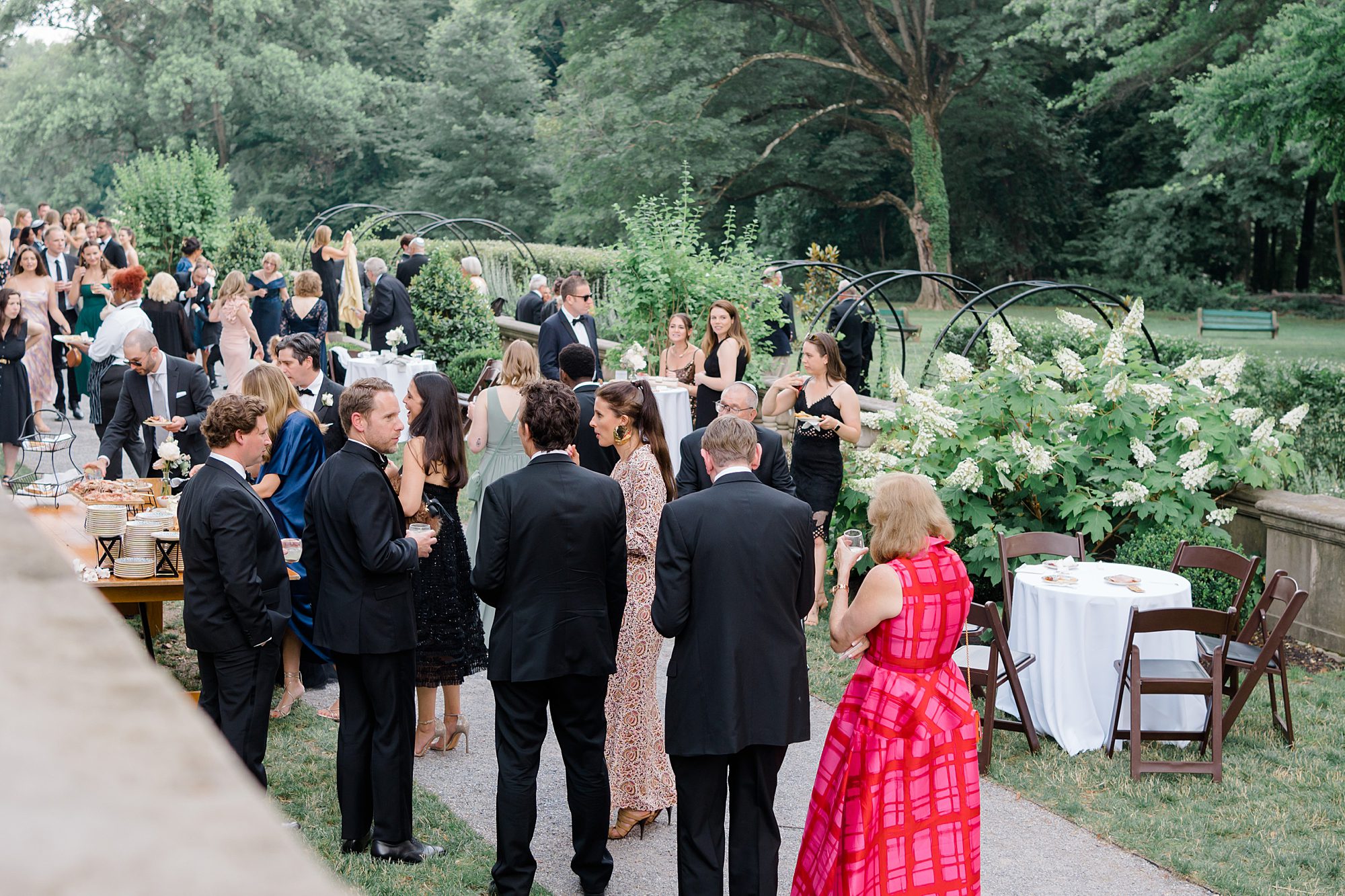 wedding guests gather in garden at Curtis Arboretum 