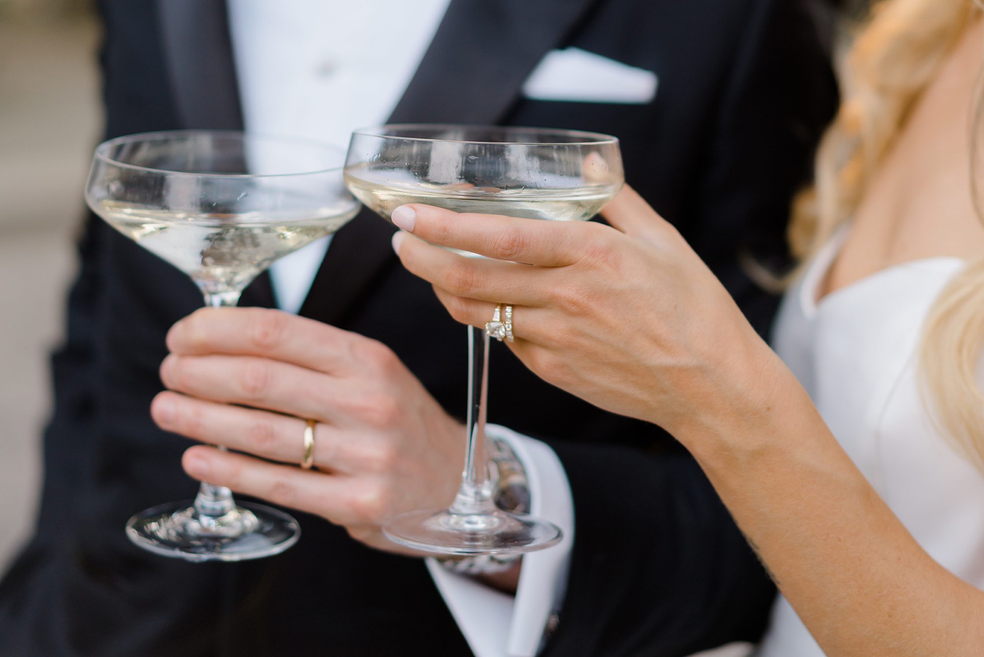 newlyweds hold champagne glasses