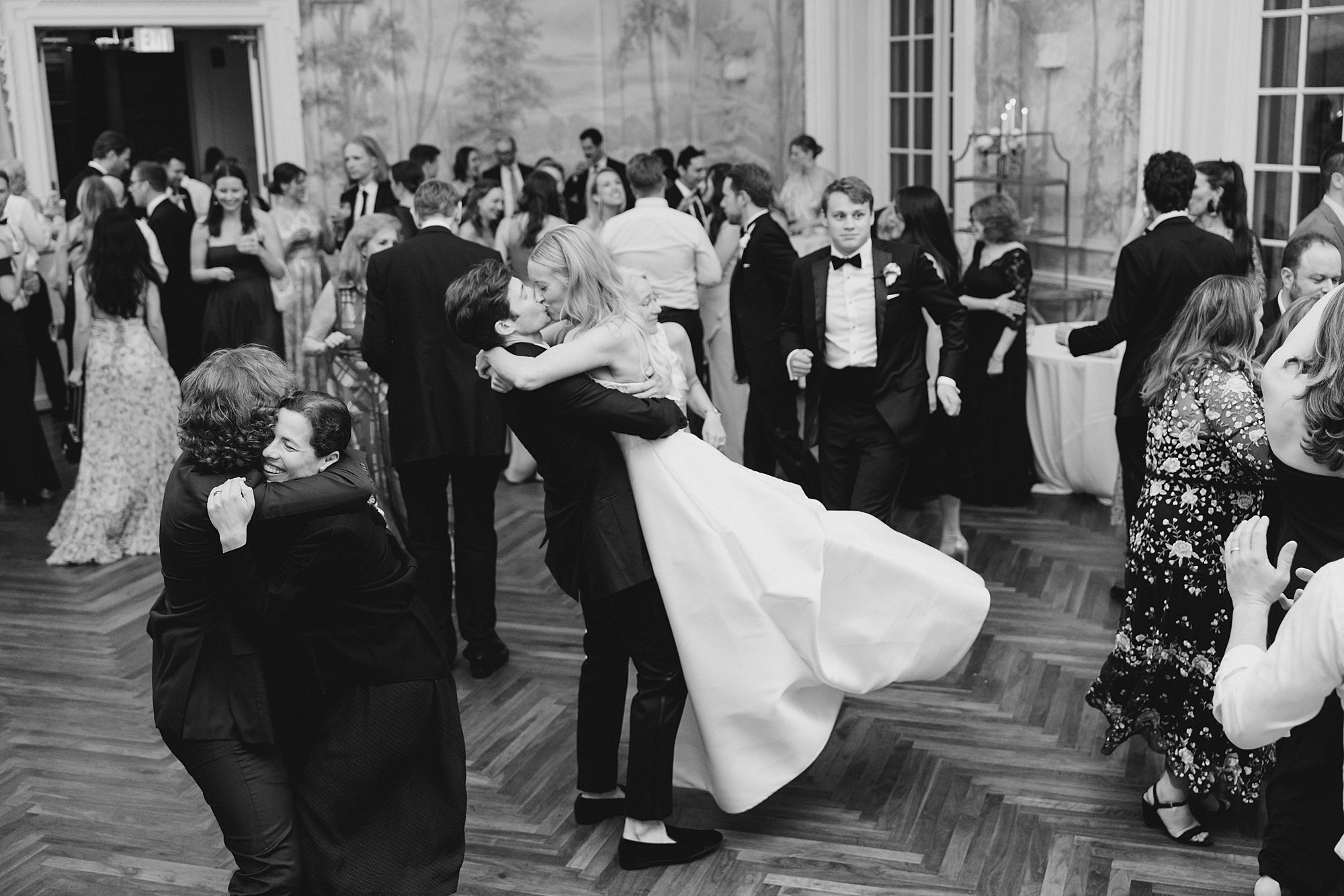 couple kiss on the dance floor of Summer Wedding at Curtis Arboretum 
