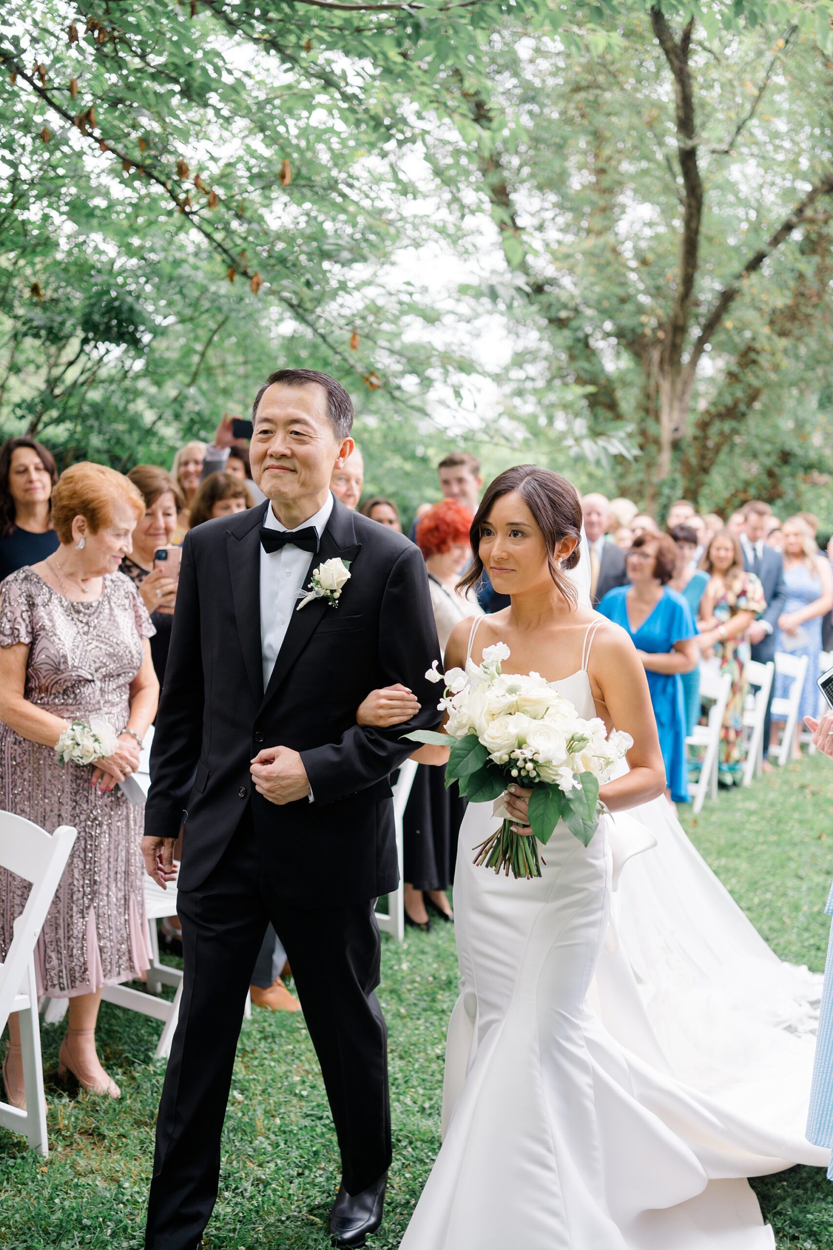 bride walks down the aisle with father