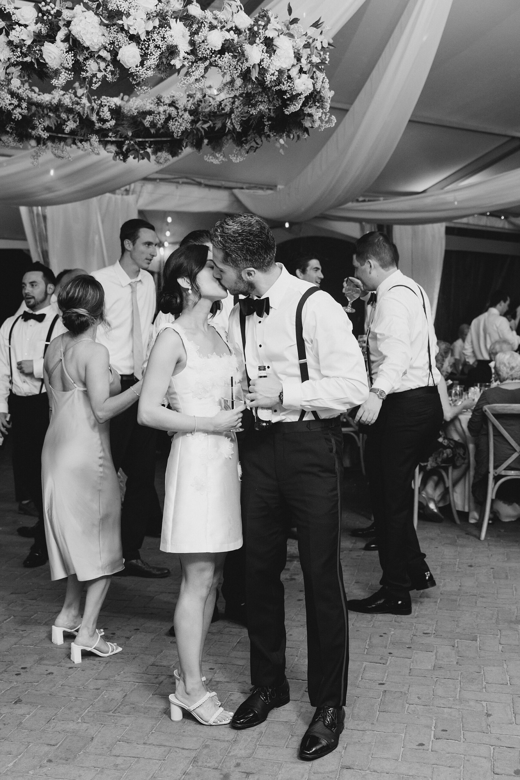 bride and groom kiss during wedding reception