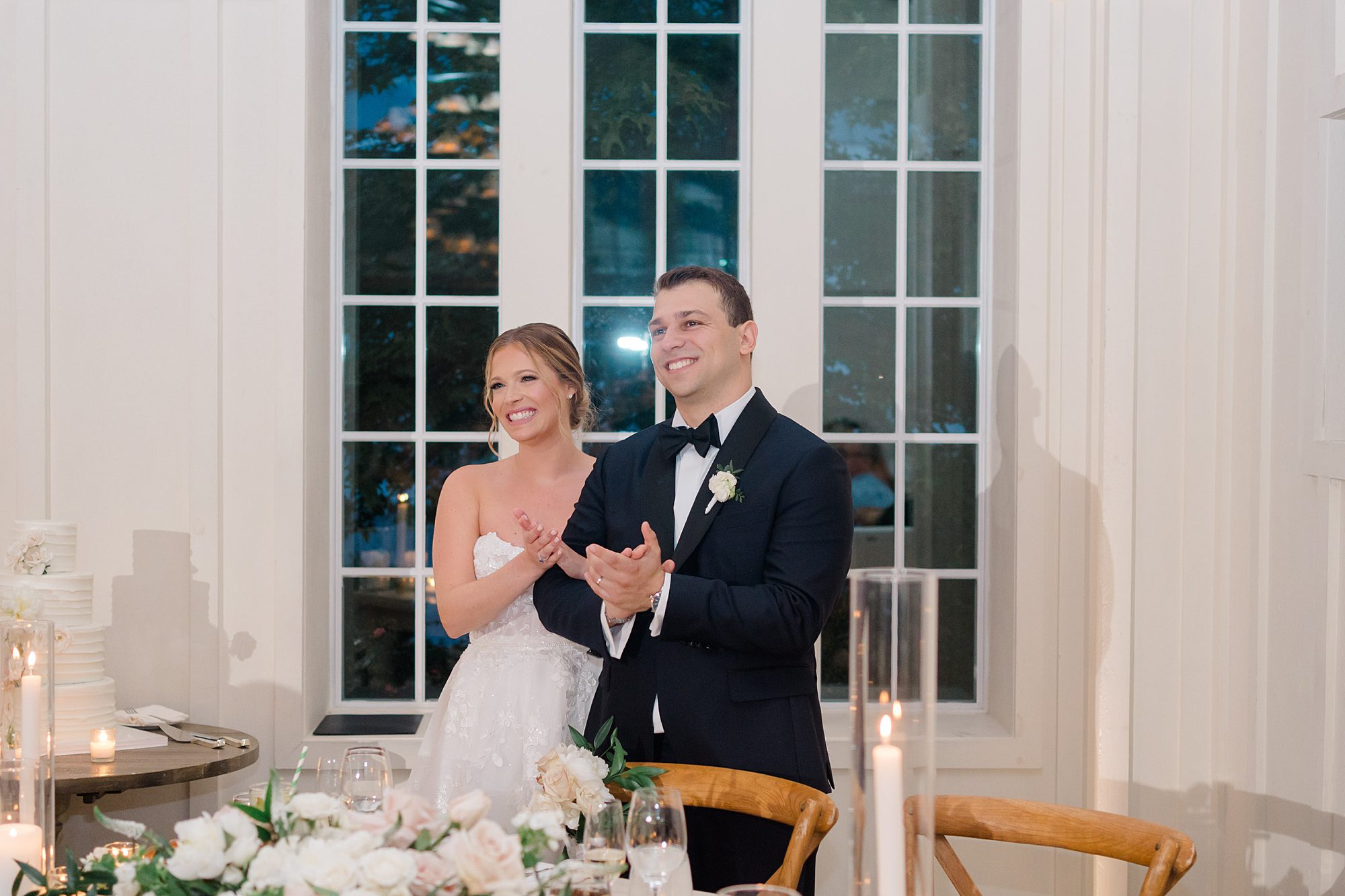 bride and groom clap during wedding speeches