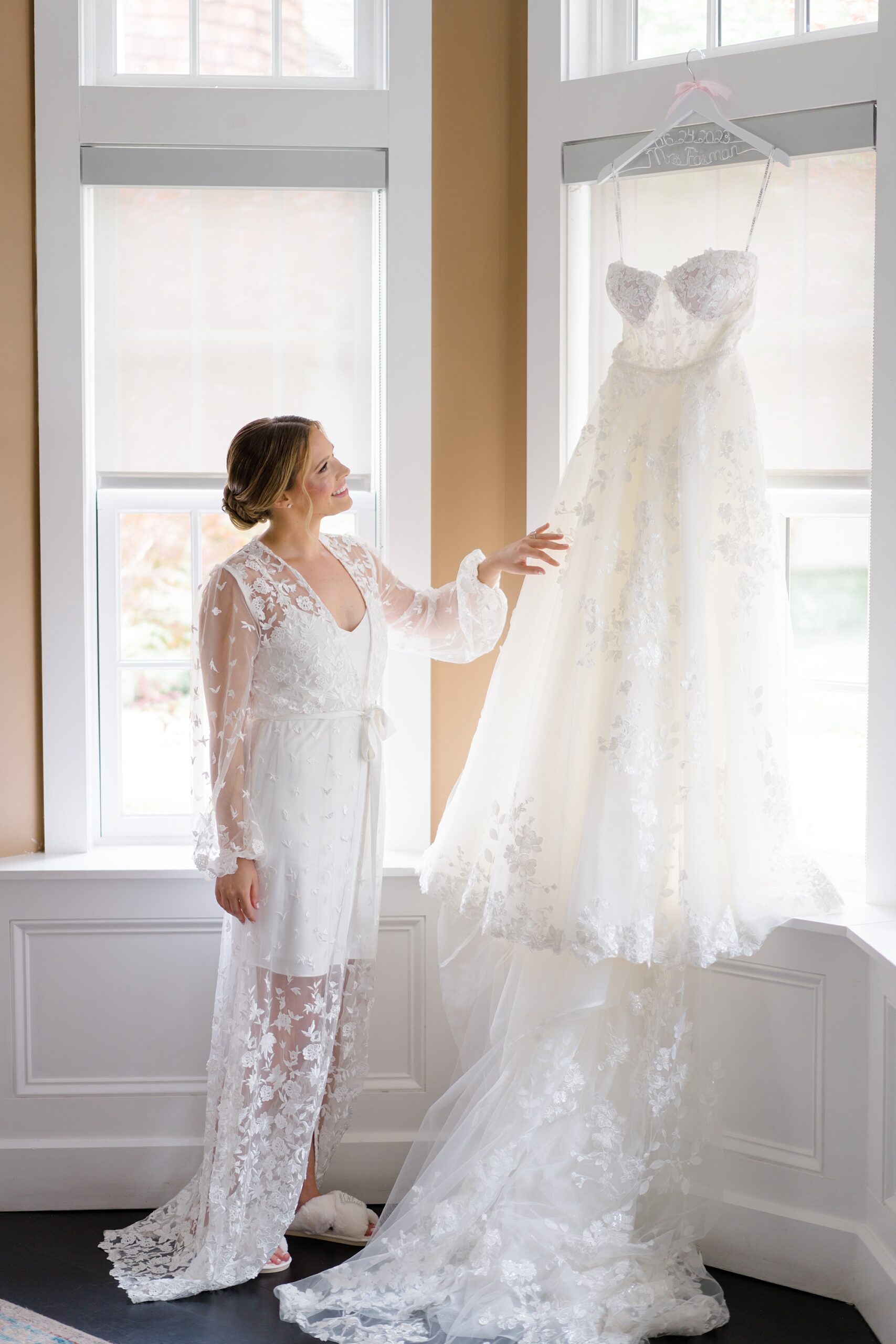 bride admires wedding dress