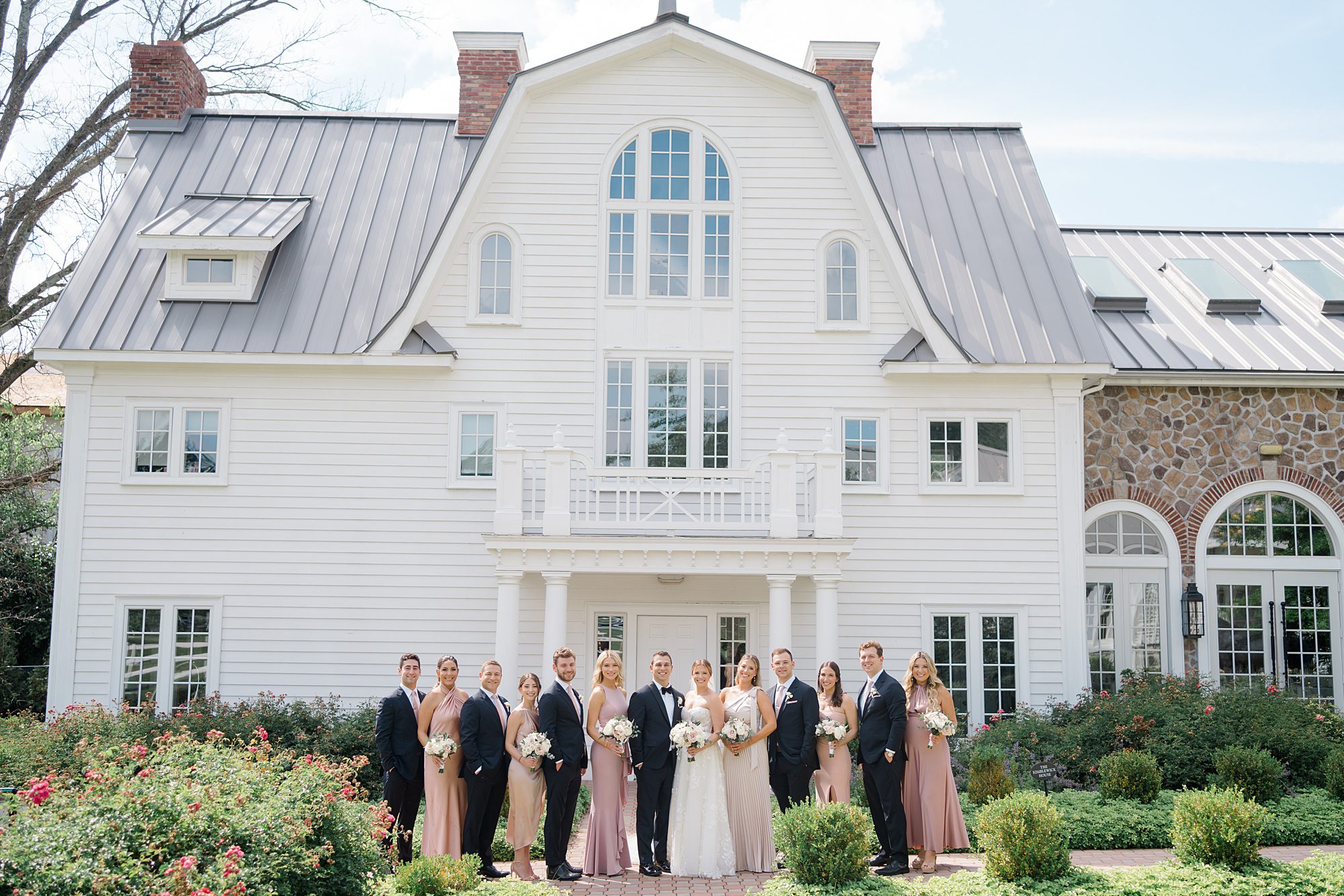 wedding party portraits in front of the Coach House at The Ryland Inn