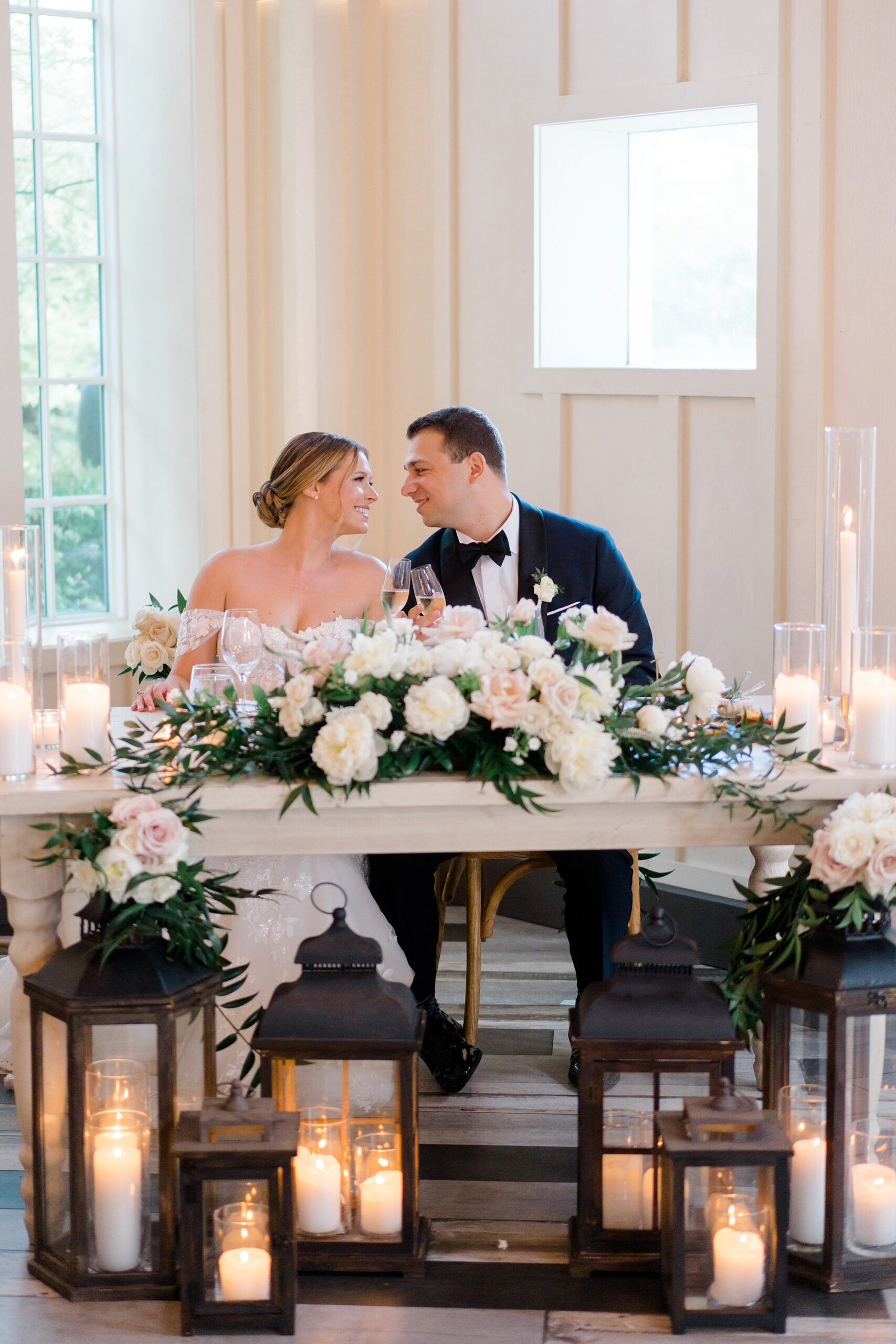 newlyweds at their sweetheart table from Coach House Wedding reception at The Ryland Inn