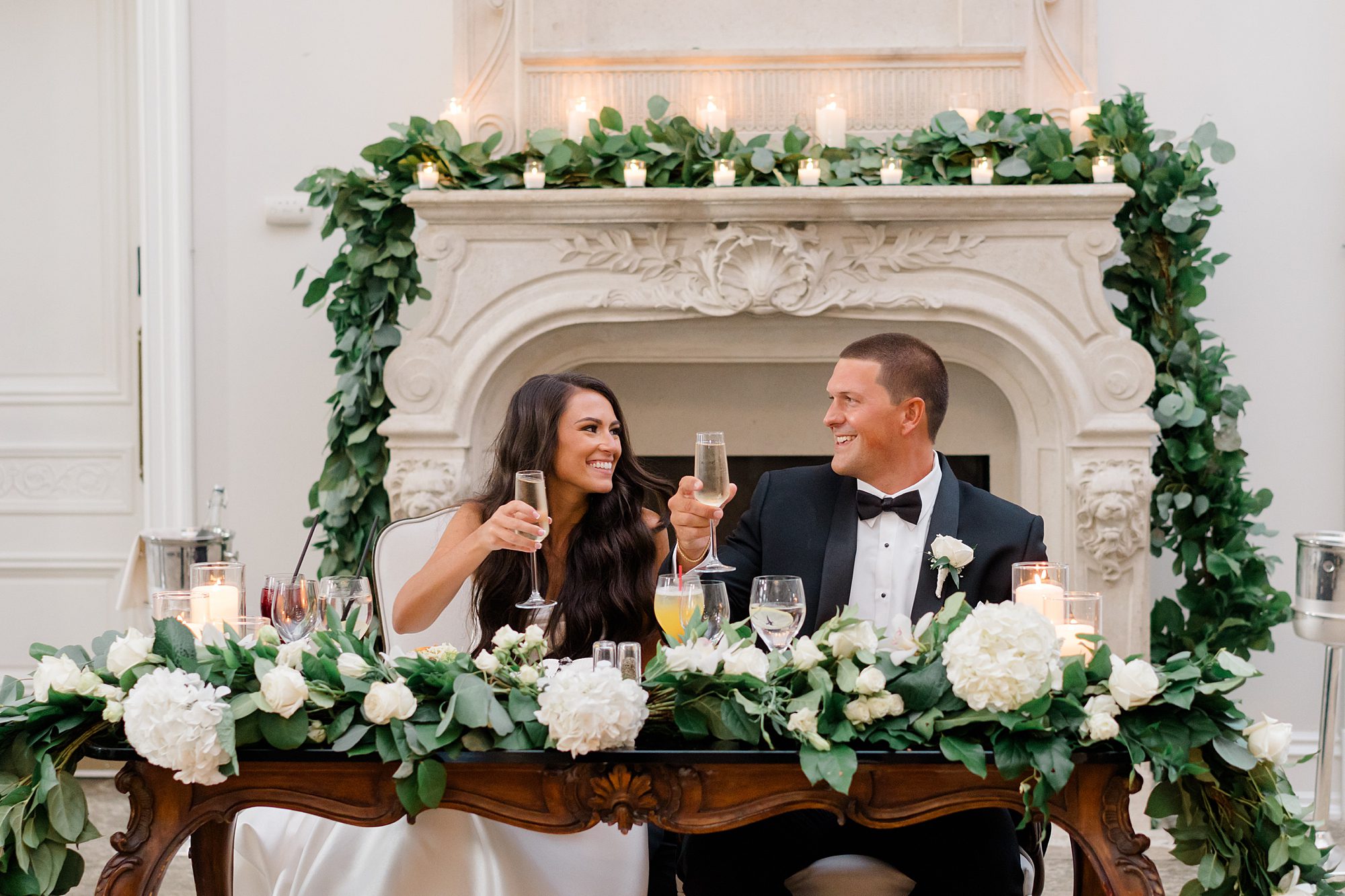 newlyweds raise glasses during wedding toasts