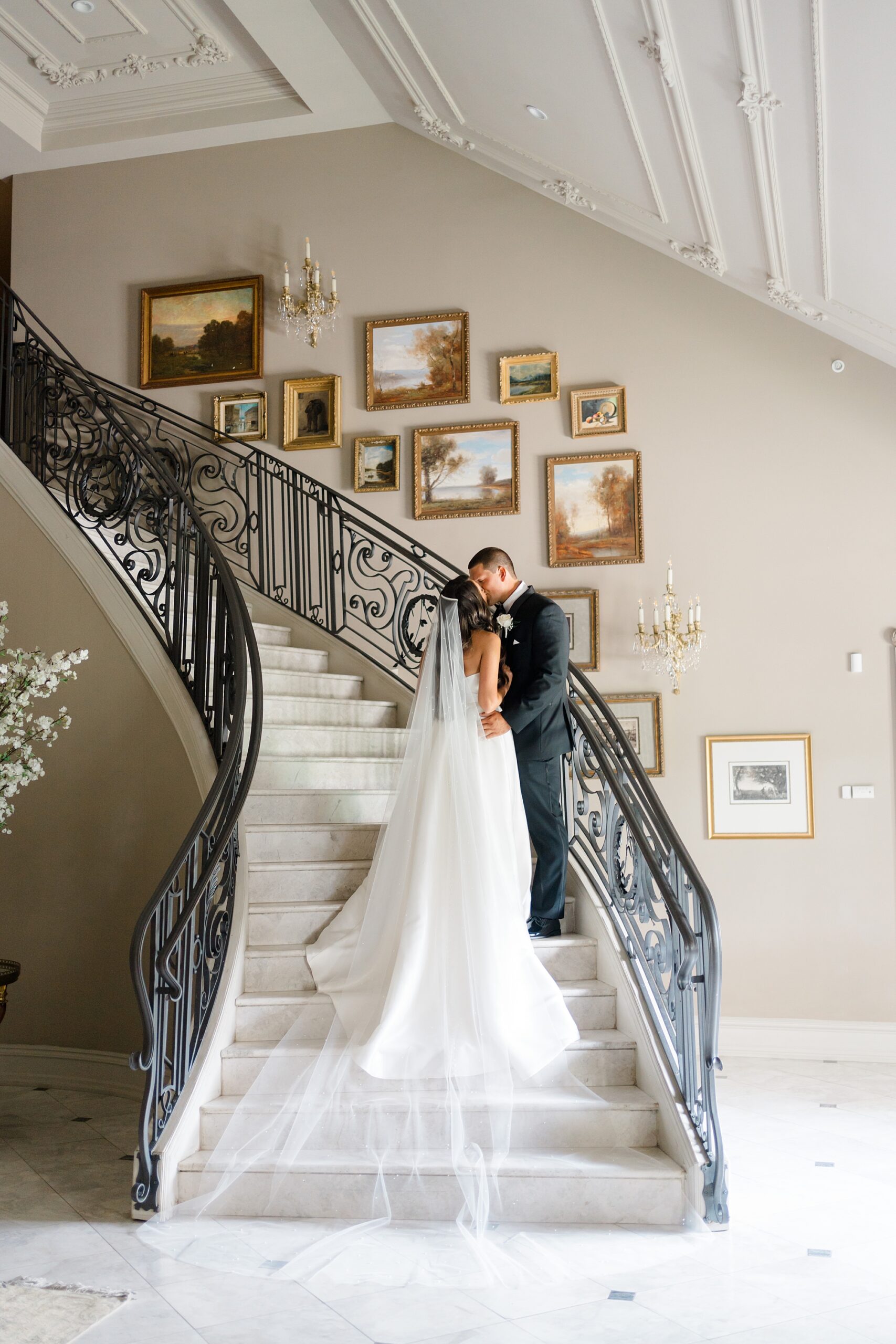 wedding portraits on grand staircase of Park Chateau