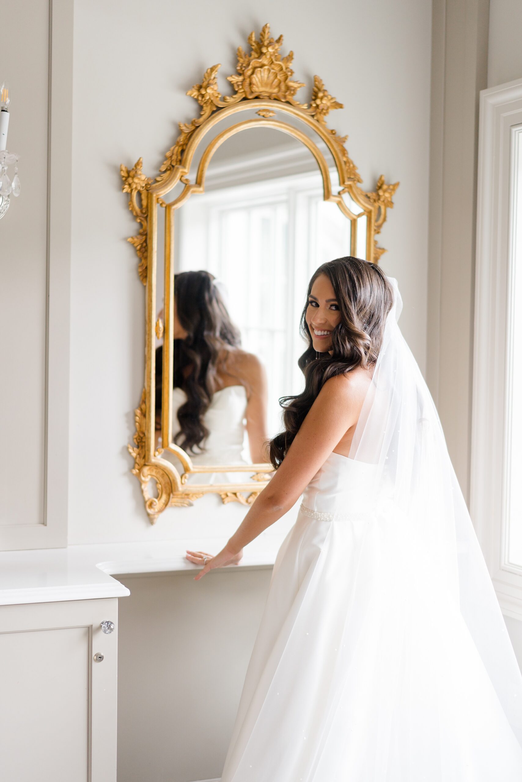 bride looking into mirror getting ready