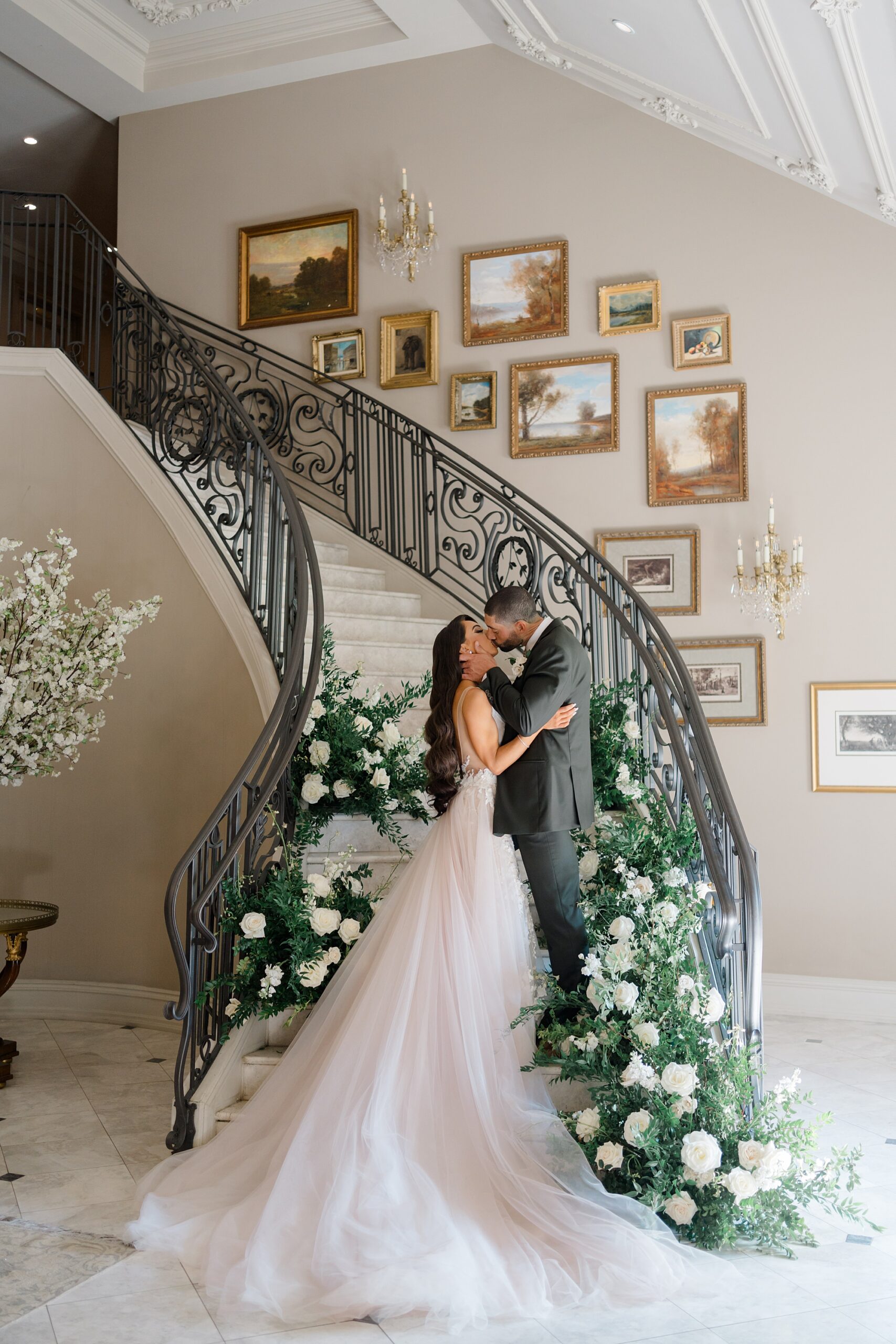 newlywed portraits on winding staircase at Park Chateau 