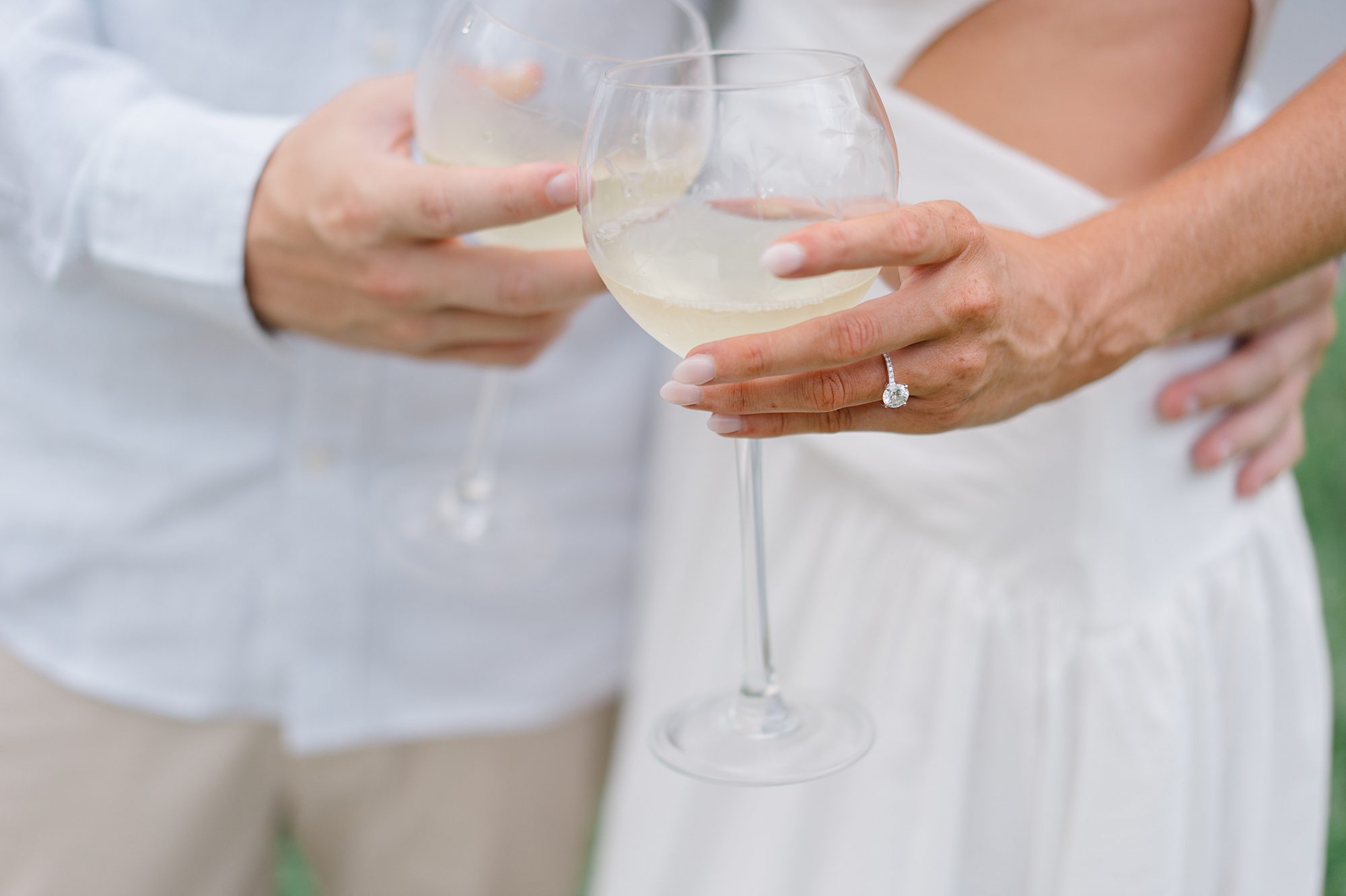 couple celebrate engagement with glass of wine