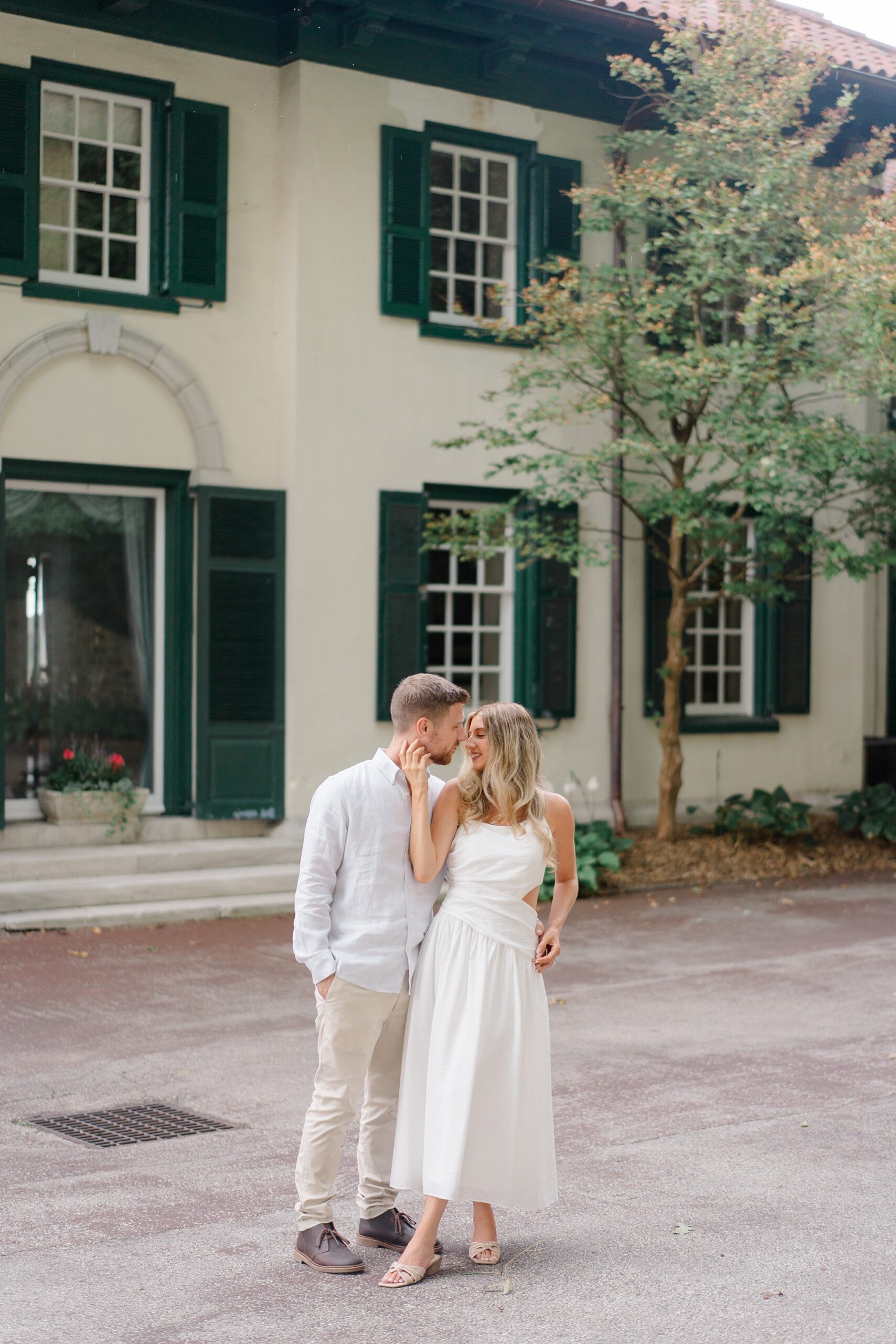 engaged couple in front of mansion at  The Willows