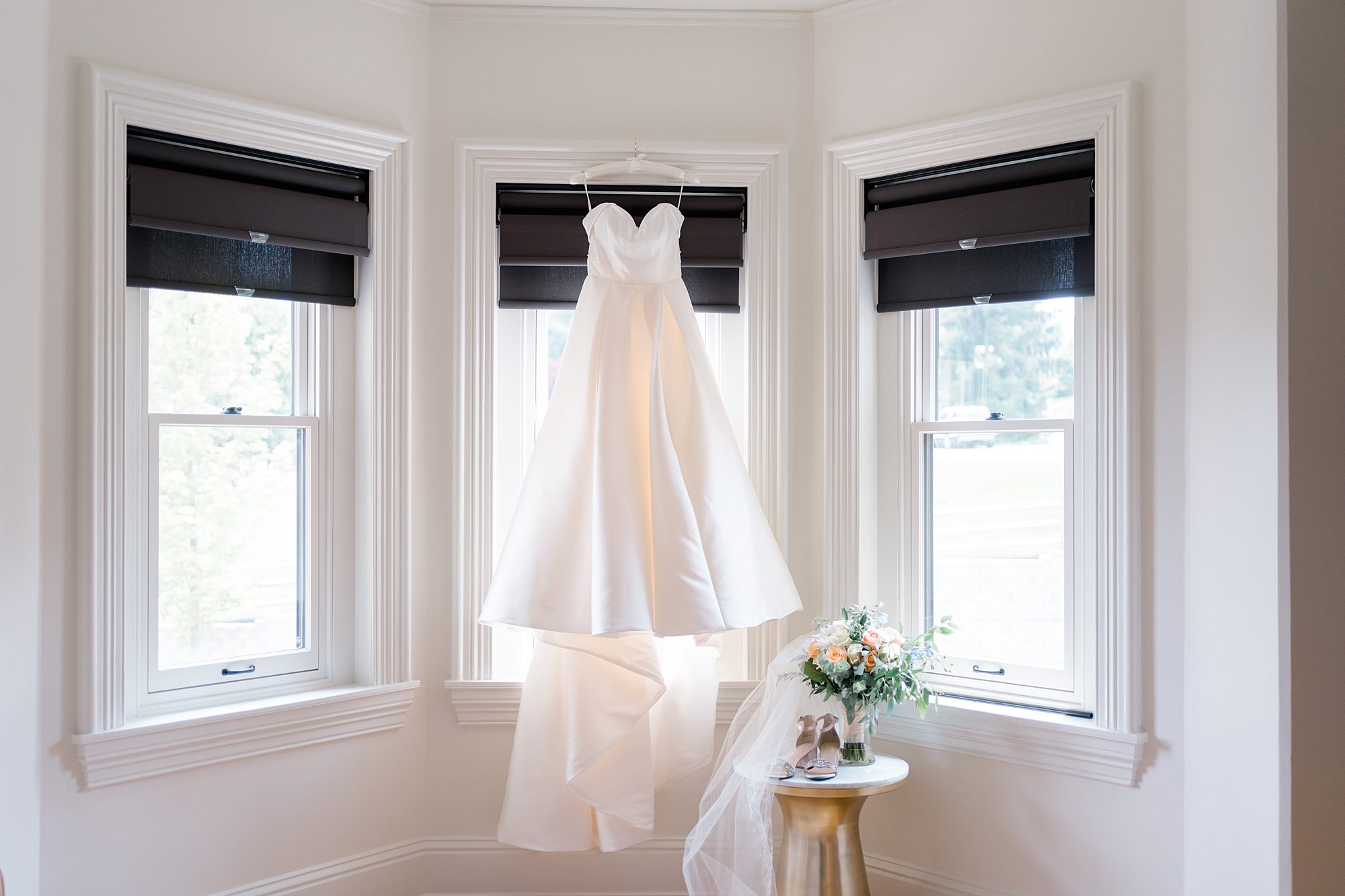 bridal wedding dress hanging in bridal suite
