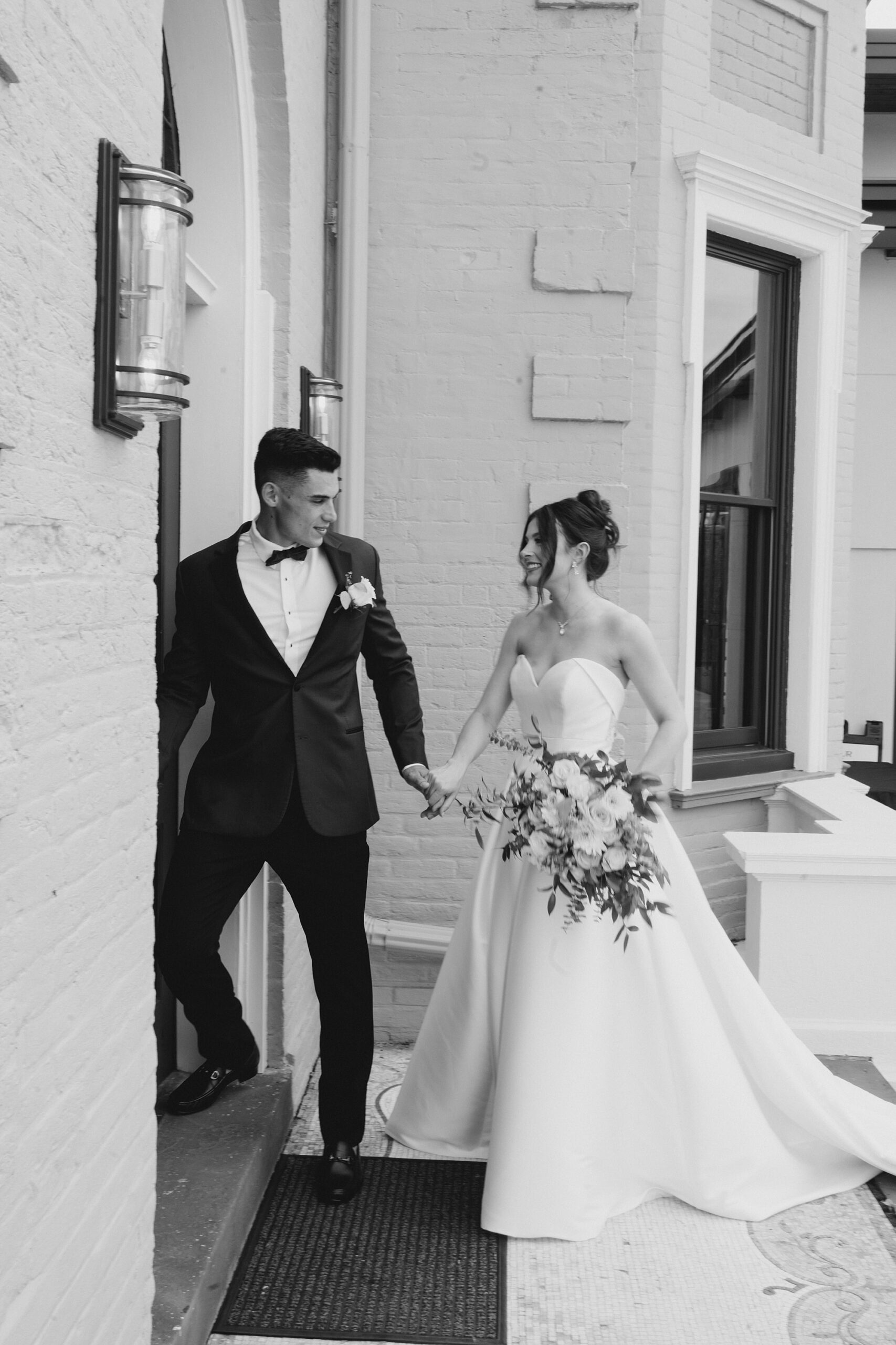 bride and groom walk into Wilbur Mansion
